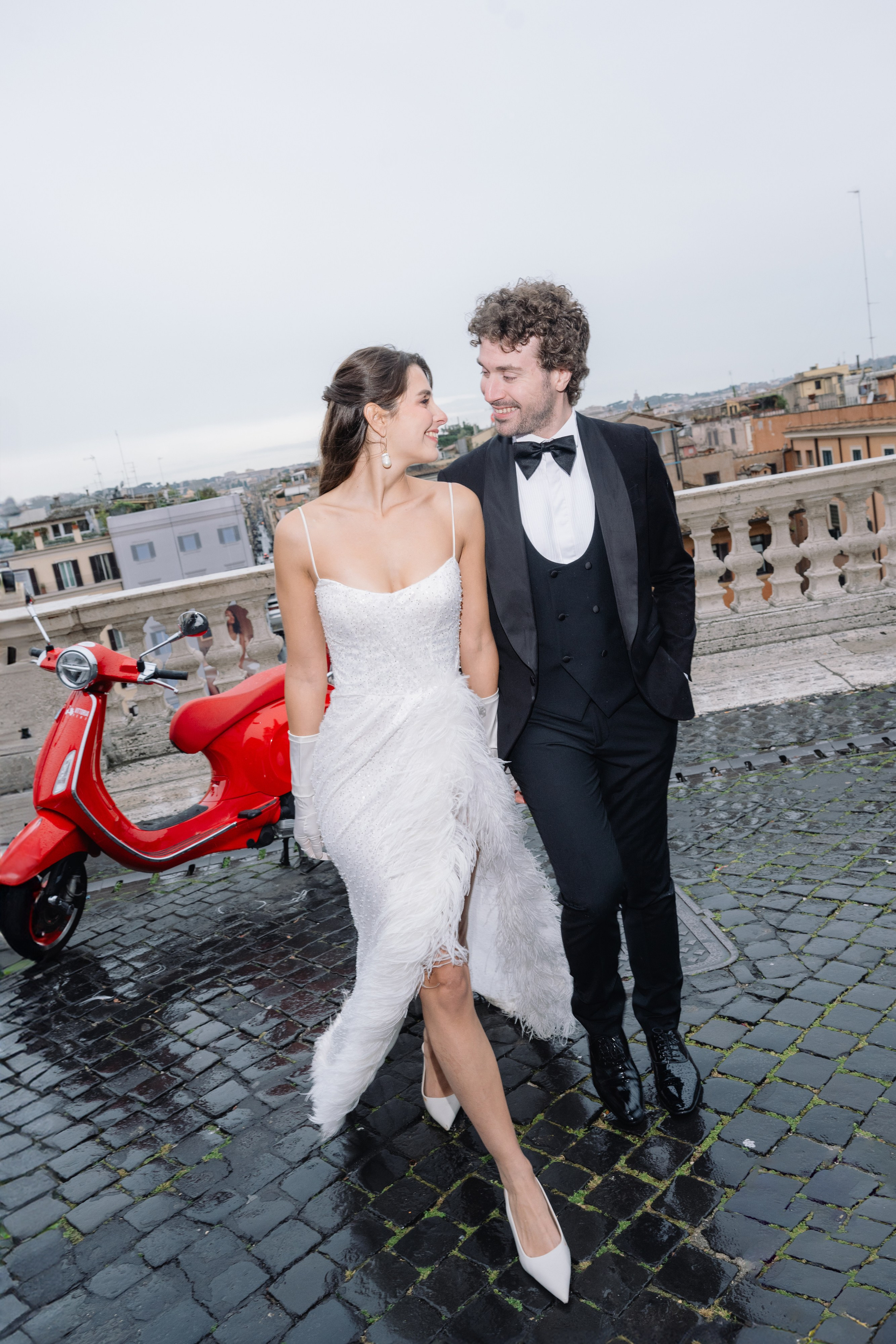 A cinematic elopement in Rome at sunrise, with quiet cobblestone streets, a vintage Vespa, and the Trevi Fountain in the rain