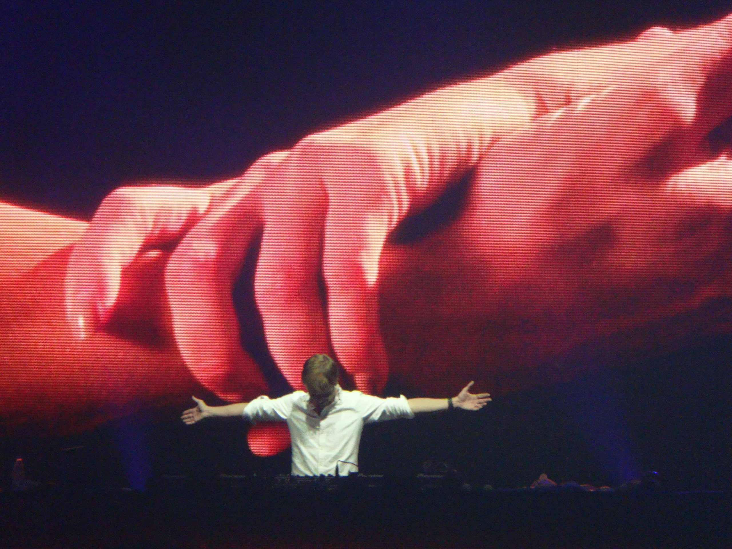 Armin van Buuren in his iconic pose with arms outstretched and head bowed down during a performance at the ASOT festival