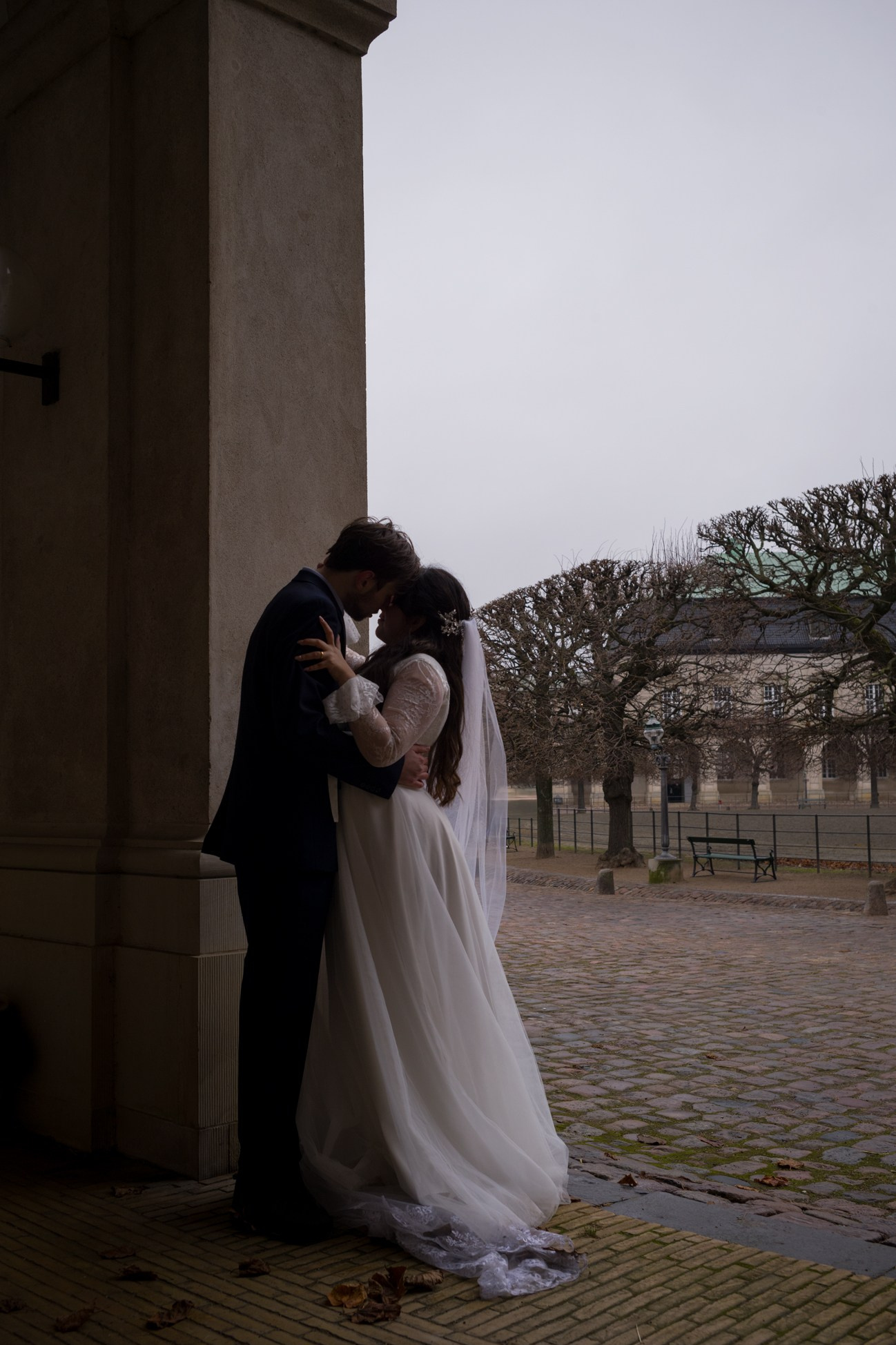Couple standing close, enjoying a tender moment in Copenhagen