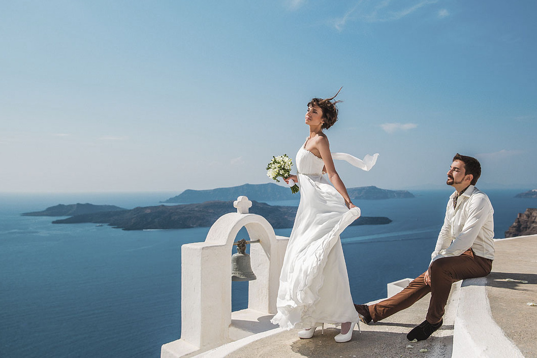 Пара на церемонии на фоне моря на Санторини. Фотосессия, видеограф в Греции.
