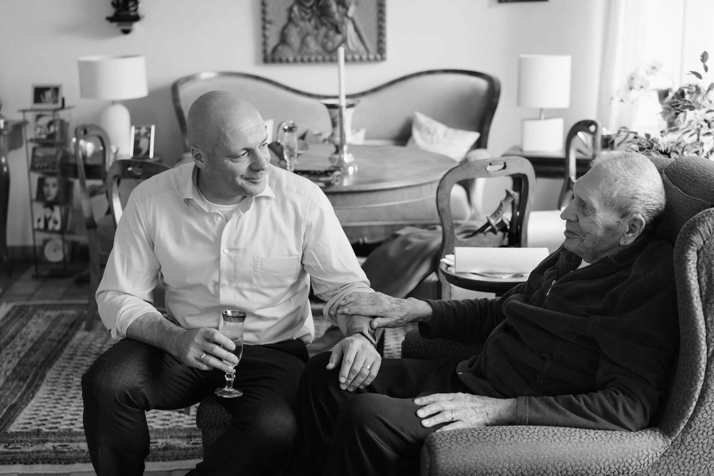 Groom sharing a quiet moment with his father before the wedding ceremony
