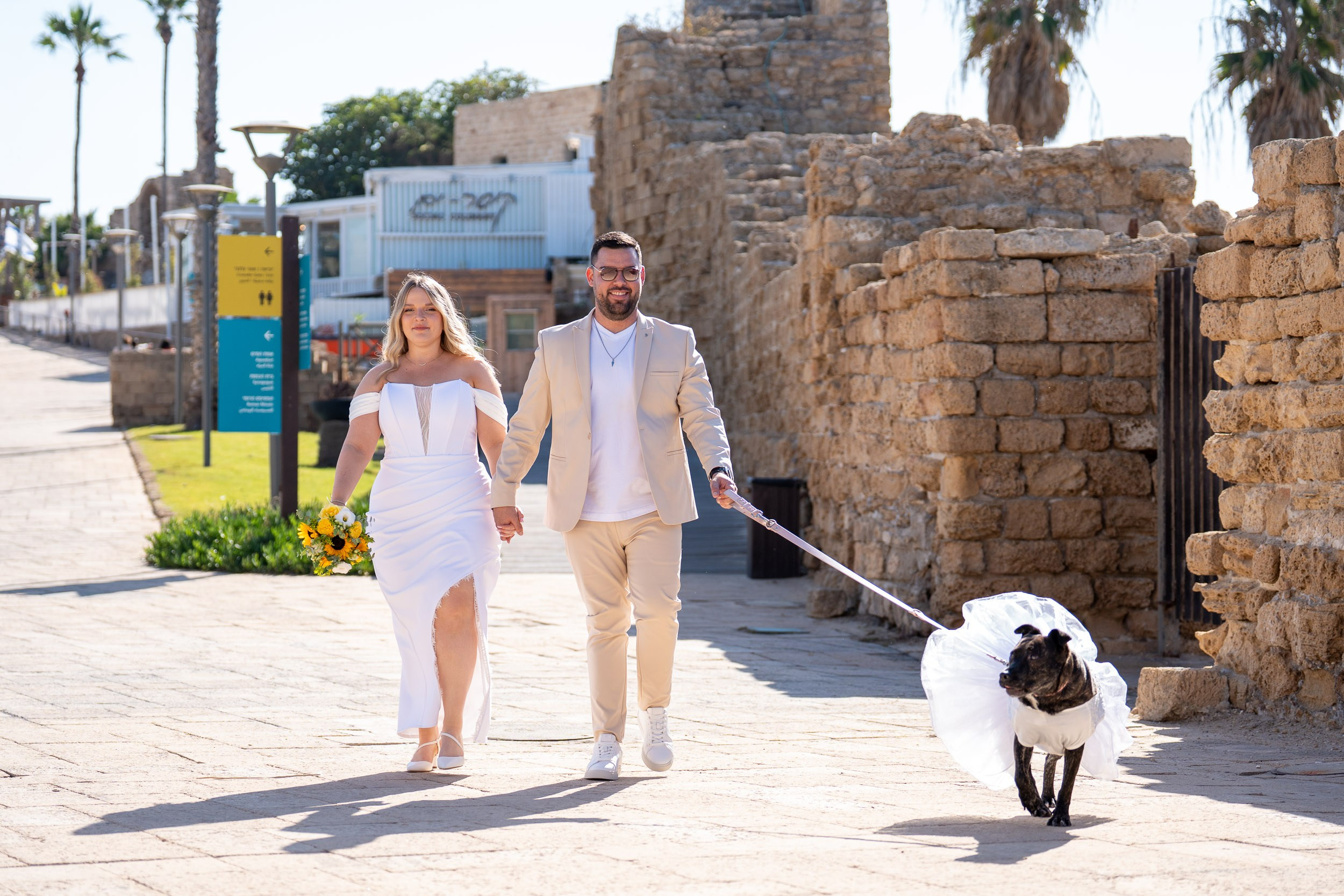 Yael and Natanel walk with their dog through the ancient streets of Caesarea