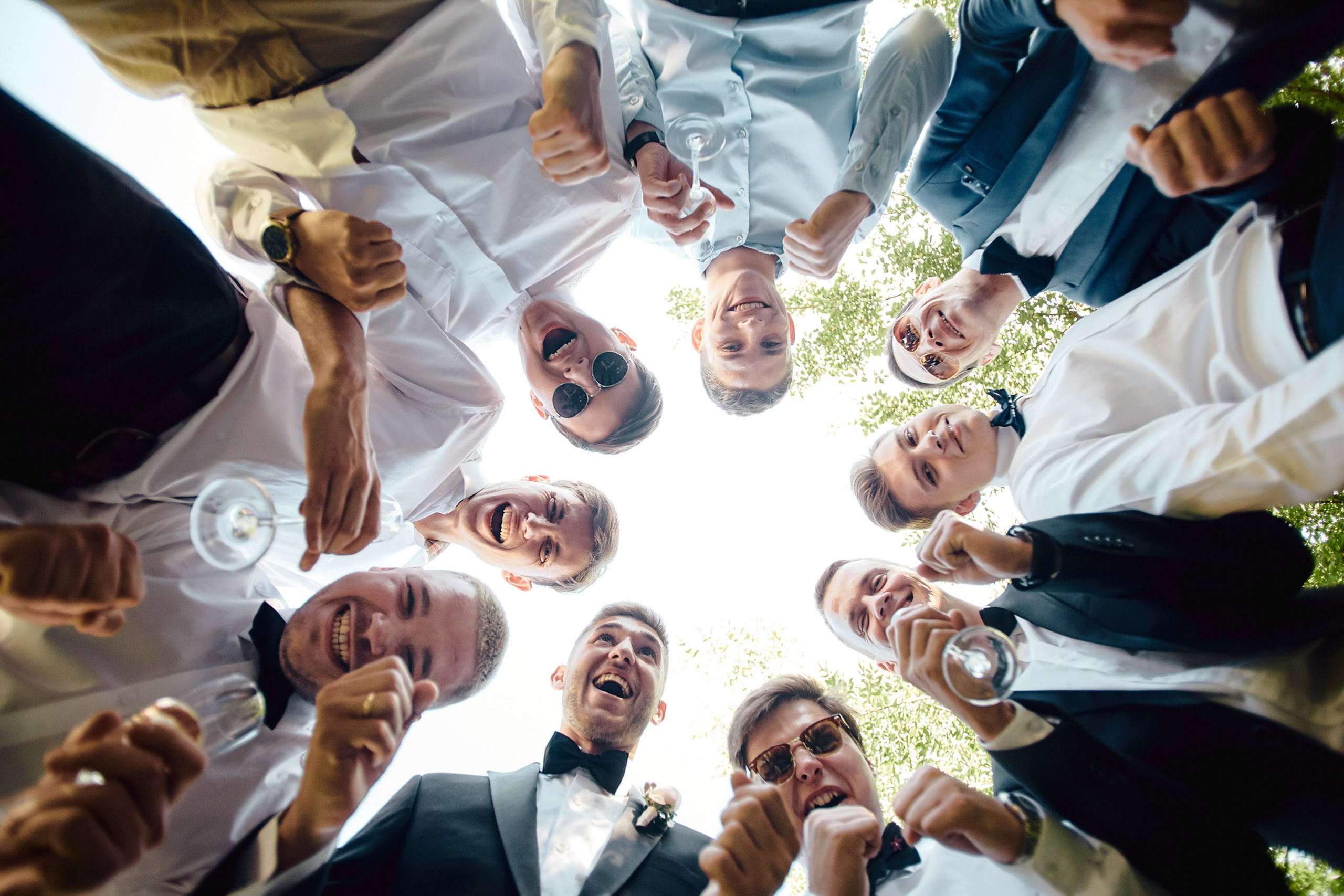 People raising glasses for a toast outdoors