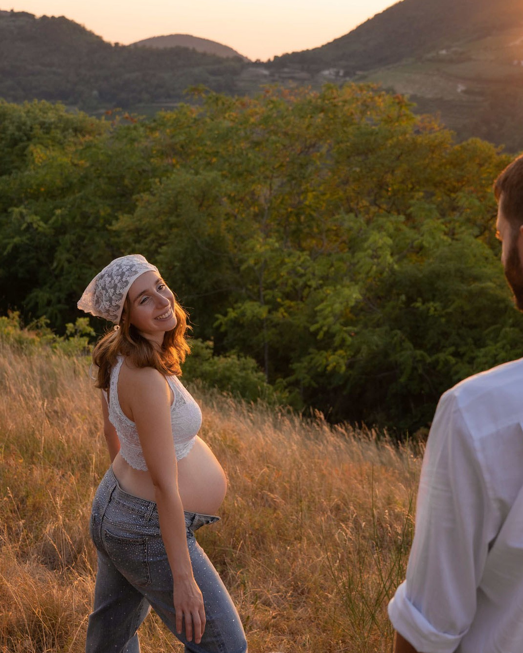 Donna incinta sorridente durante una mini sessione maternity al tramonto vicino a Padova