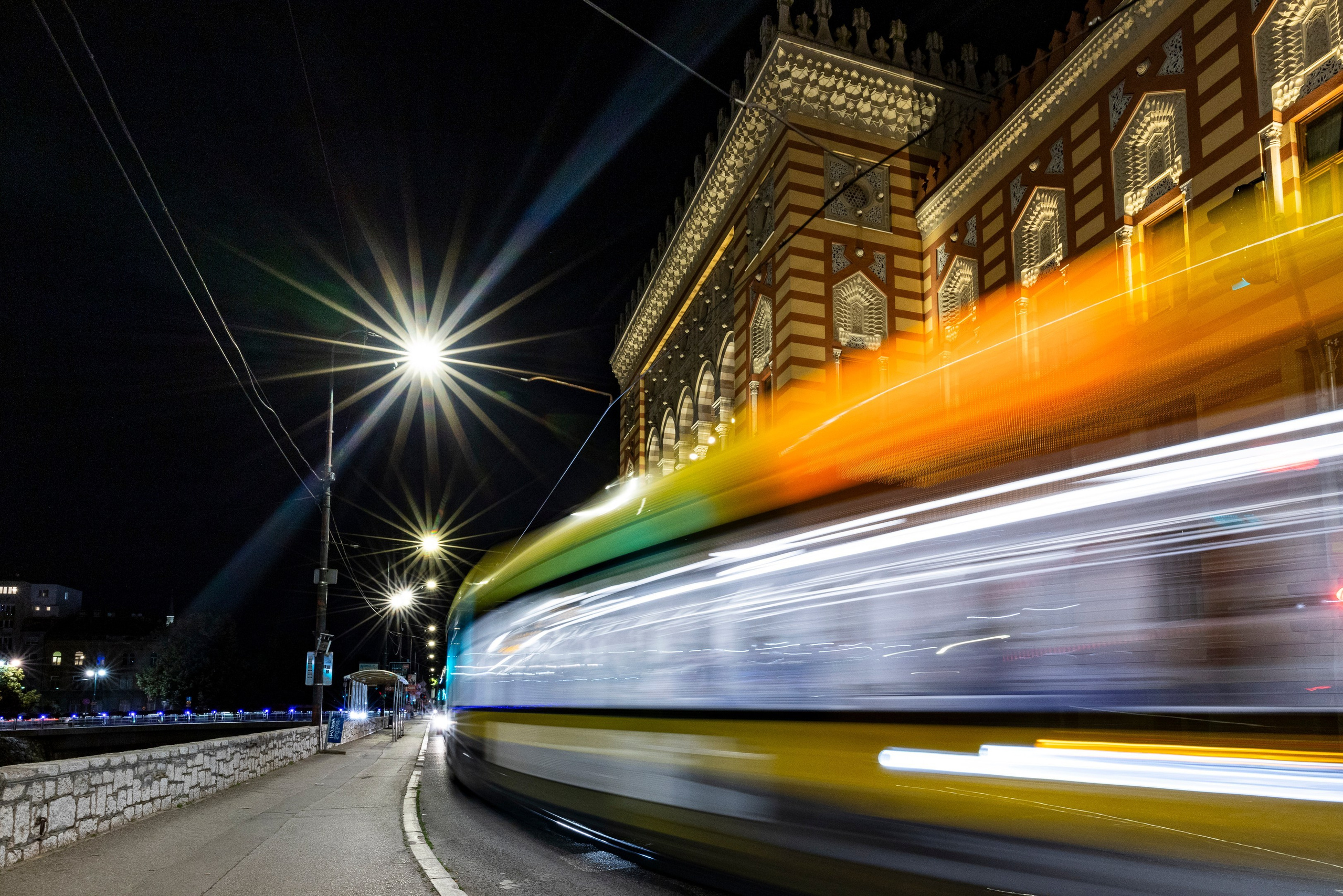 Photograph of a Sarajevo tram moving in front of the historic City Hall (Vijećnica), one of the most iconic landmarks of Sarajevo and Bosnia and Herzegovina.