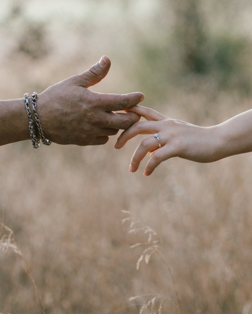 Close up of hands touching before a surprise marriage proposal, intimate engagement moment in Verona
