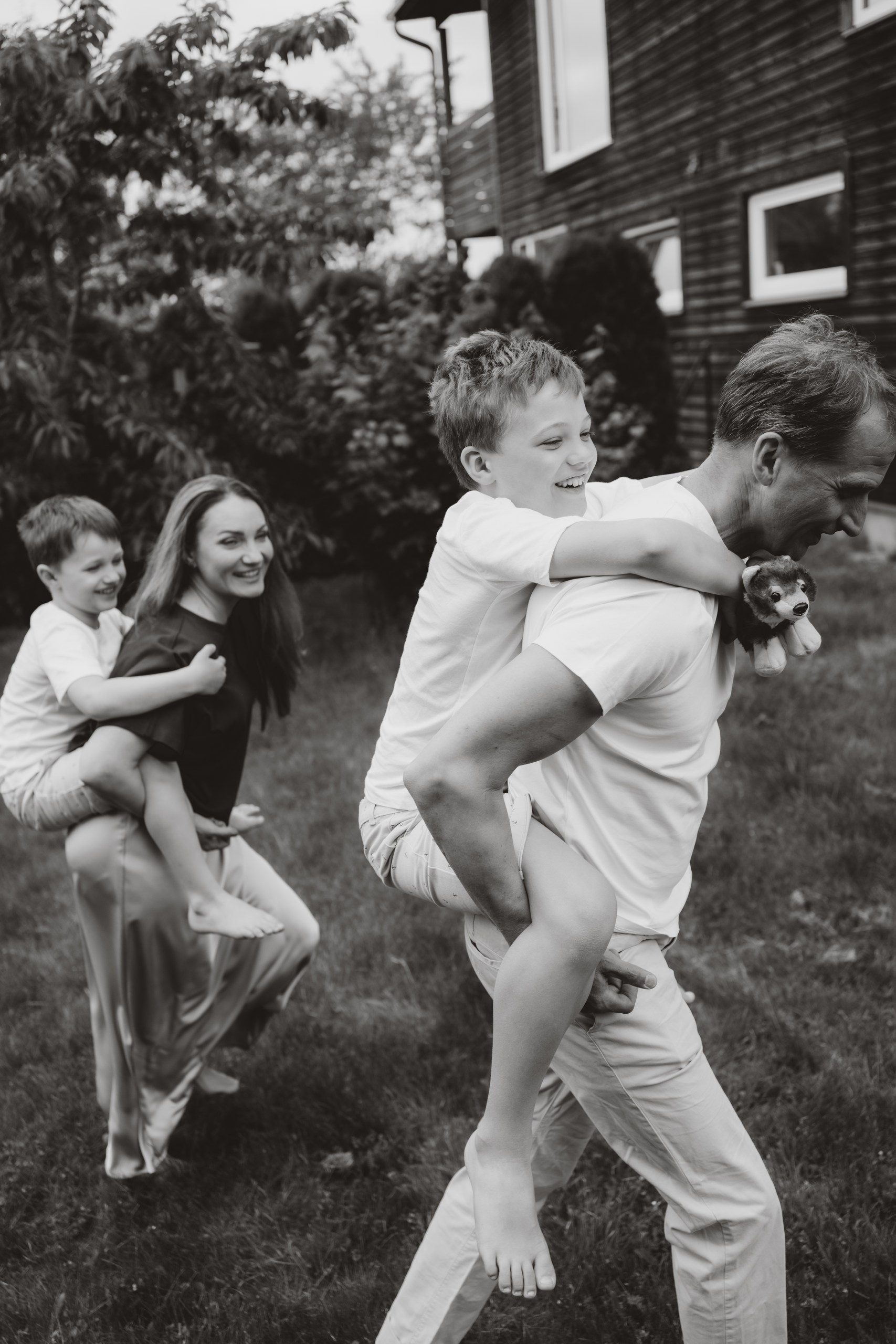 Documentary family photograph of parents and children sharing a playful moment at home