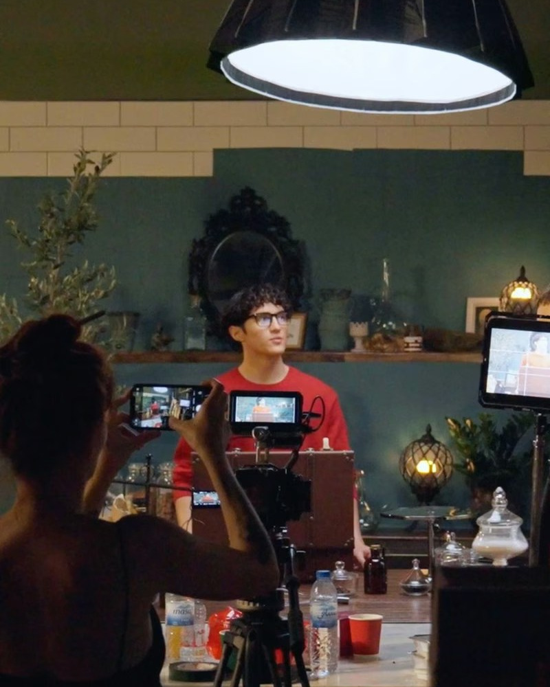 Behind-the-scenes interview recording with a cinema camera, monitor and studio lighting