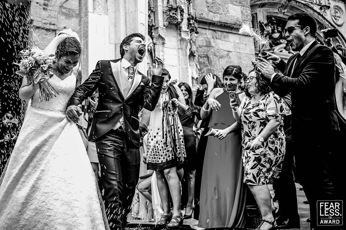 Emotional wedding moment surrounded by family — Fearless Award-winning photograph by Nuno Lopes
