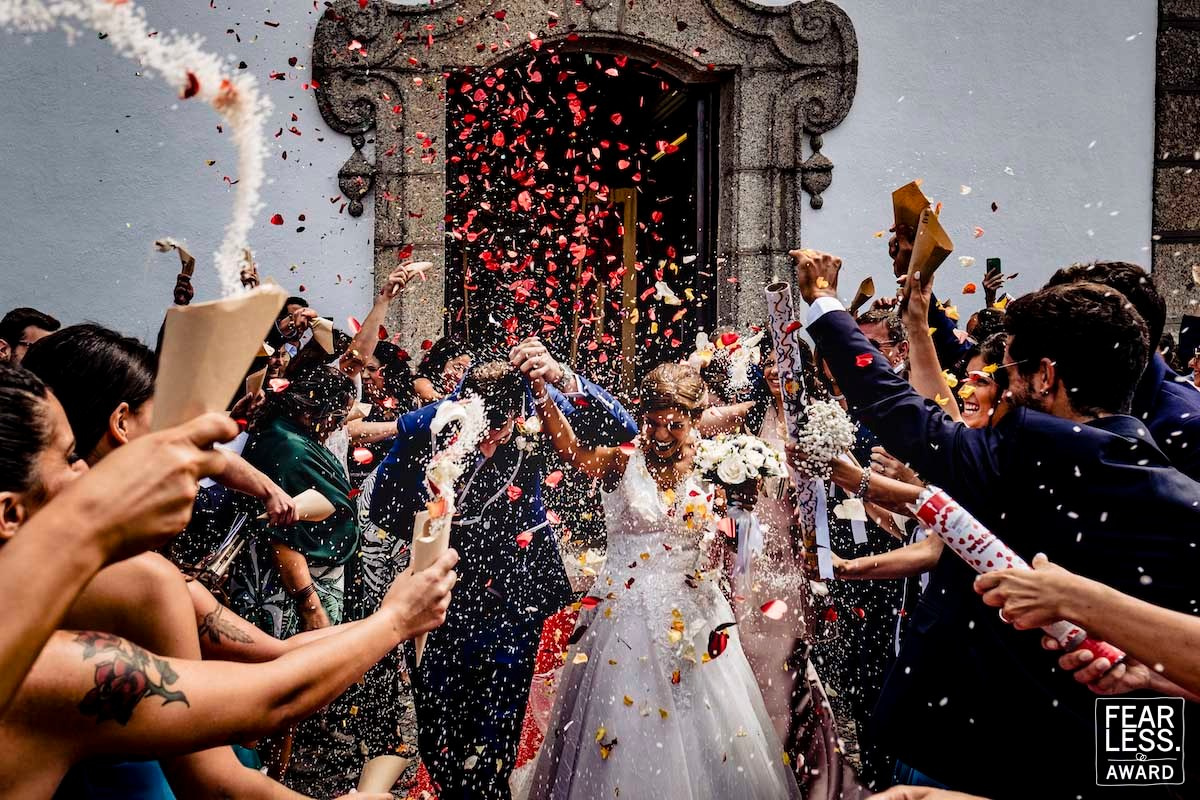 Bride and groom leaving church surrounded by confetti in Portugal - Nuno Lopes