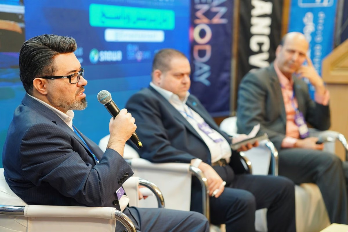 Business executives taking part in a panel discussion at a professional corporate conference