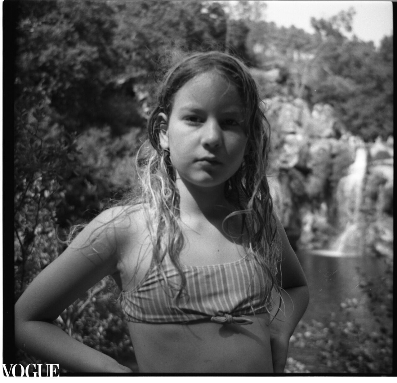 Portrait photo of a young girl and a waterfall, the picture was taken during a vacation in Portugal. Published on photo Vogue
