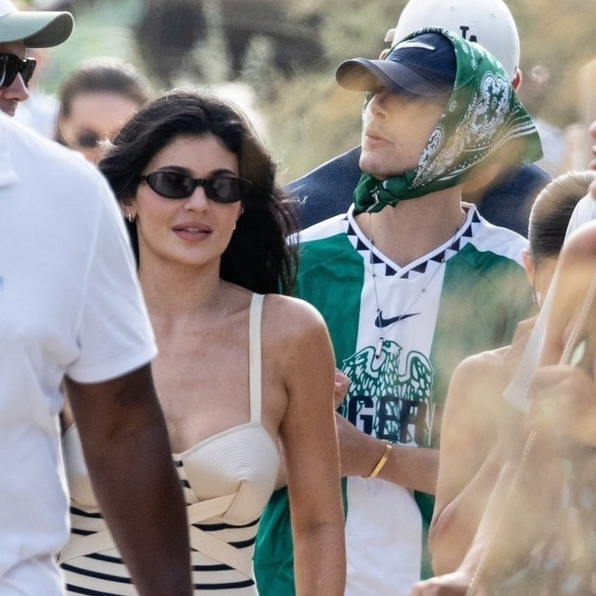 Кайли Дженнер в чёрно-белом полосатом мини-платье и Тимоти Шаламе в зелёной футболке сборной Нигерии и бандане на фестивале Coachella 2025, папарацци фото