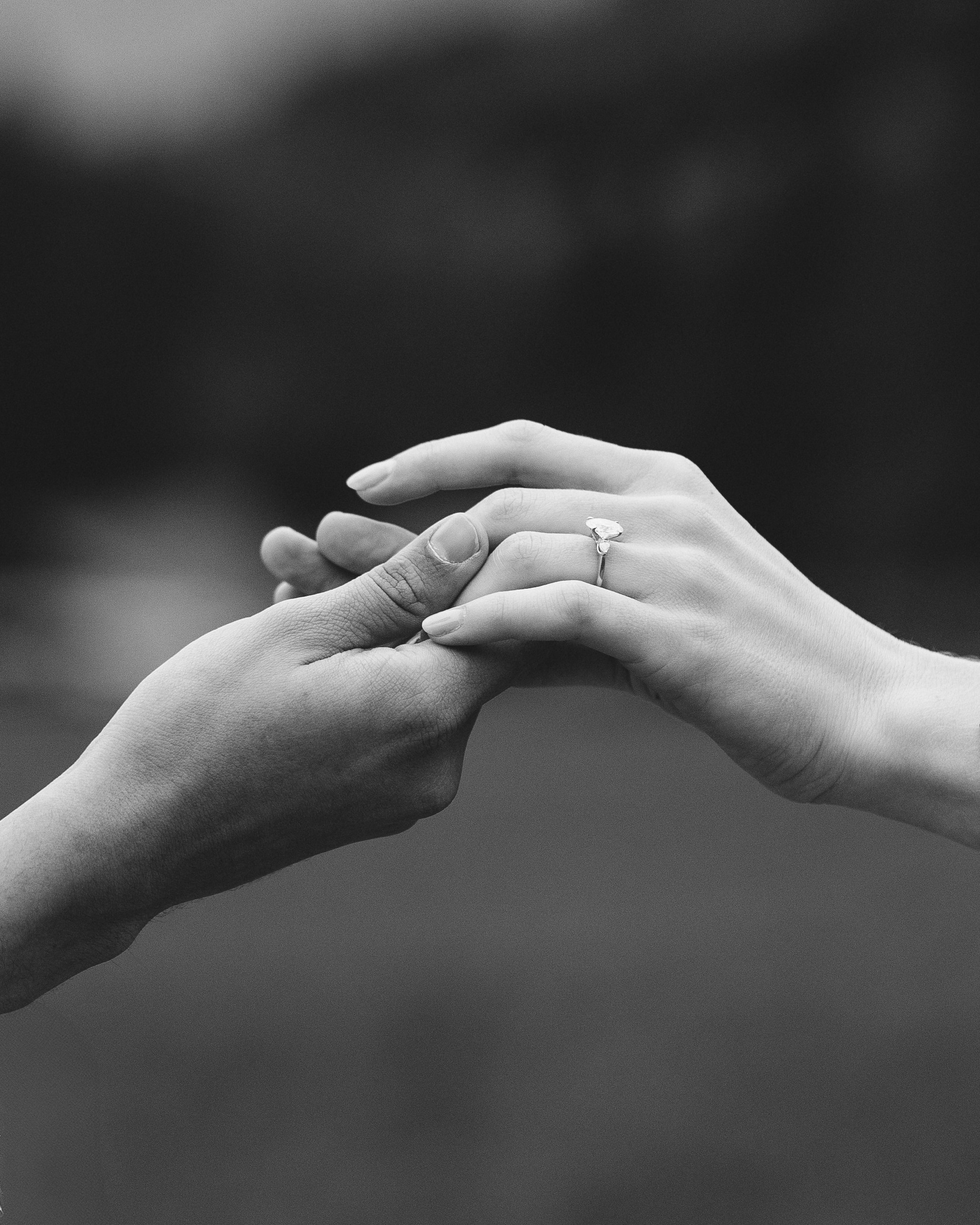 Close-up of hands during a romantic marriage proposal moment in Verona
