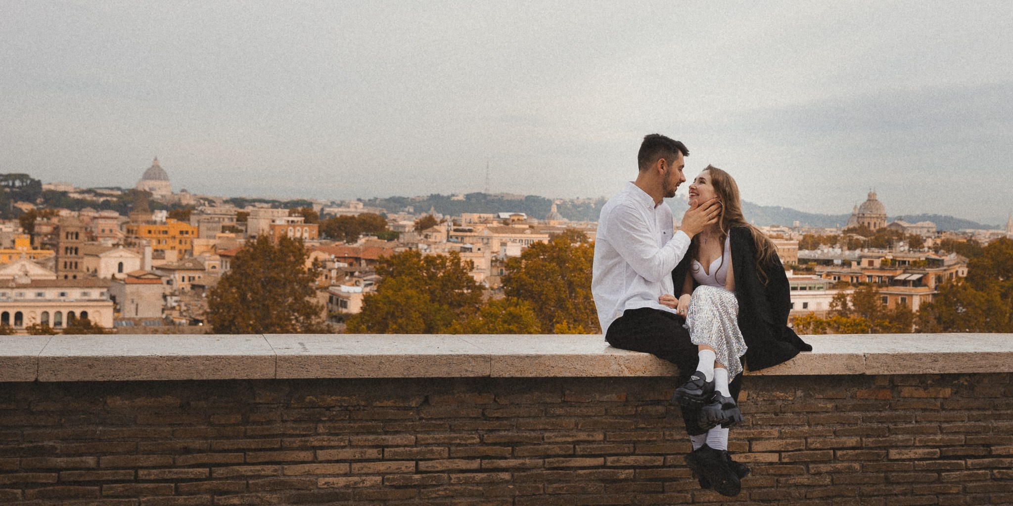 Photographer directing a couple during a photoshoot in Rome.