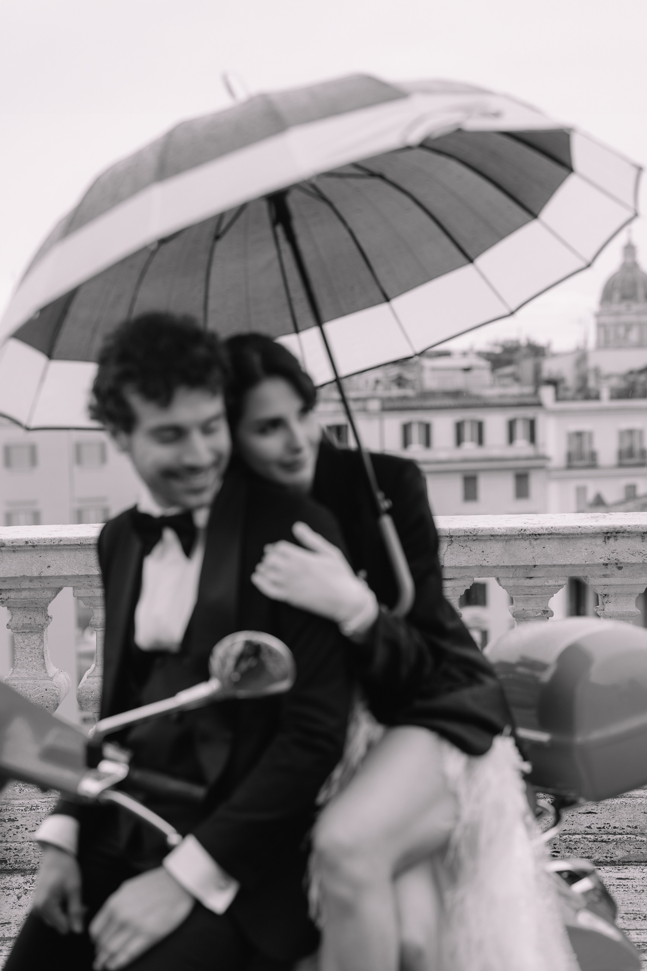 A cinematic elopement in Rome at sunrise, with quiet cobblestone streets, a vintage Vespa, and the Trevi Fountain in the rain