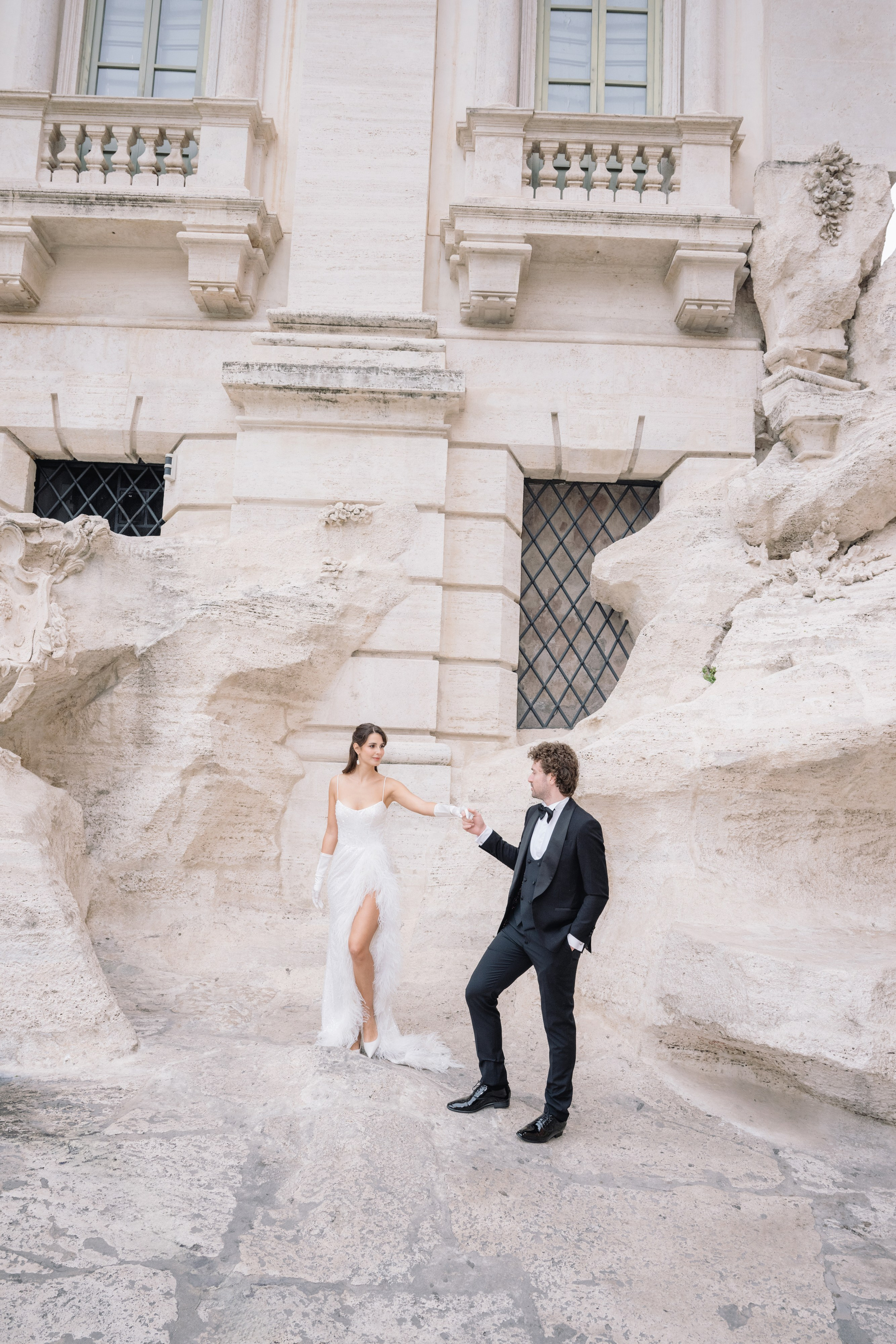 A cinematic elopement in Rome at sunrise, with quiet cobblestone streets, a vintage Vespa, and the Trevi Fountain in the rain