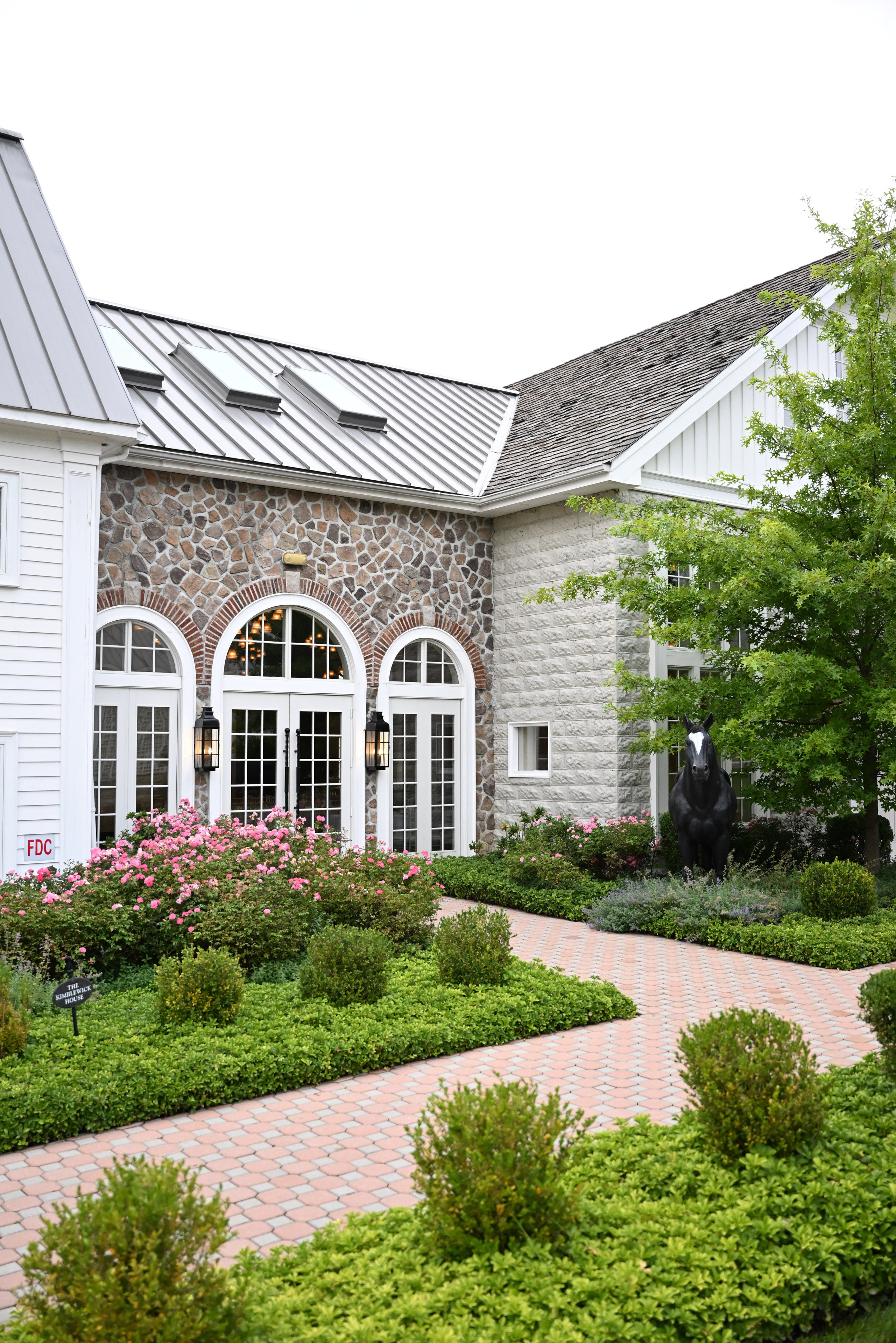 a house with a brick walkway and a stone walkway