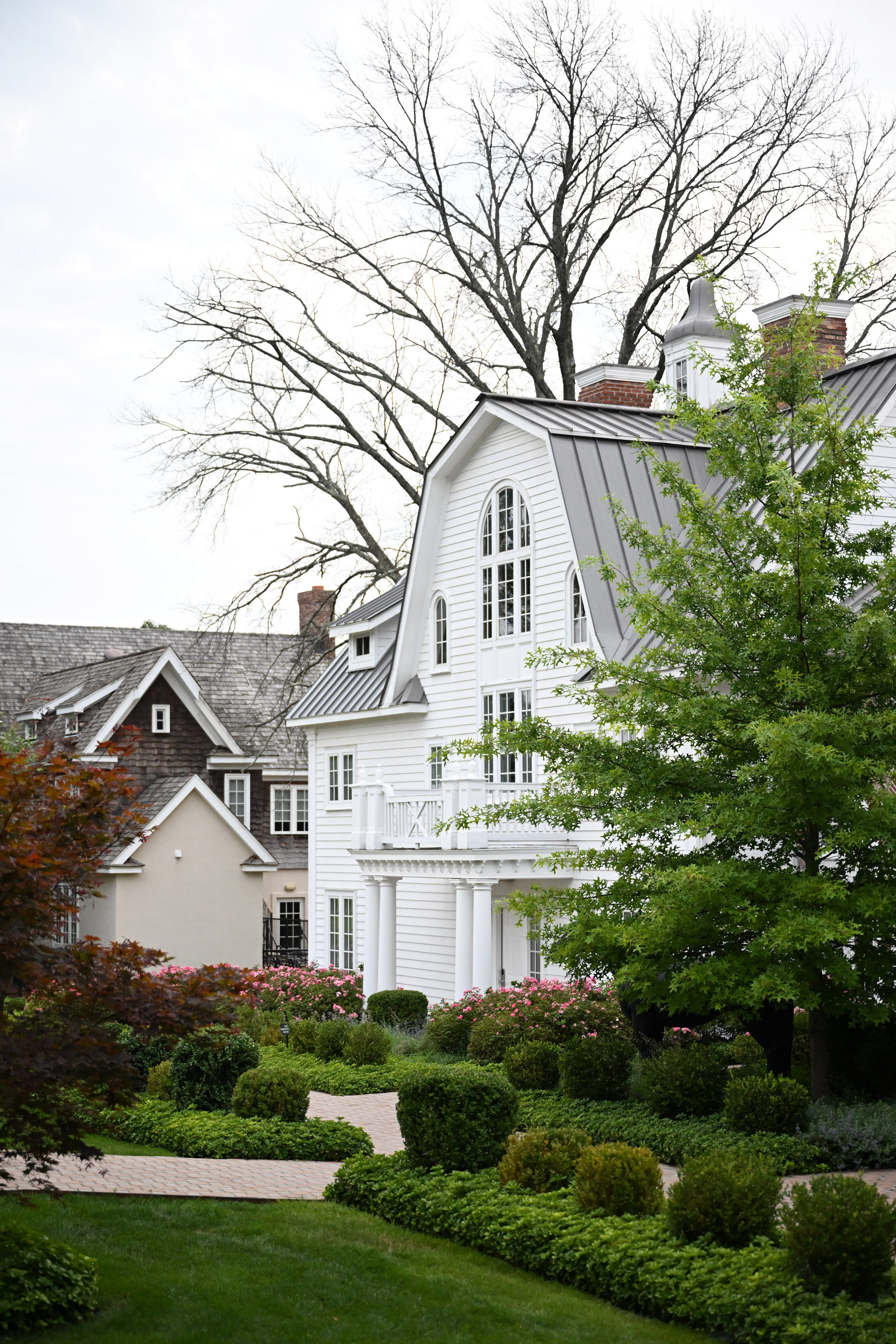 a white house with a tree in the front yard