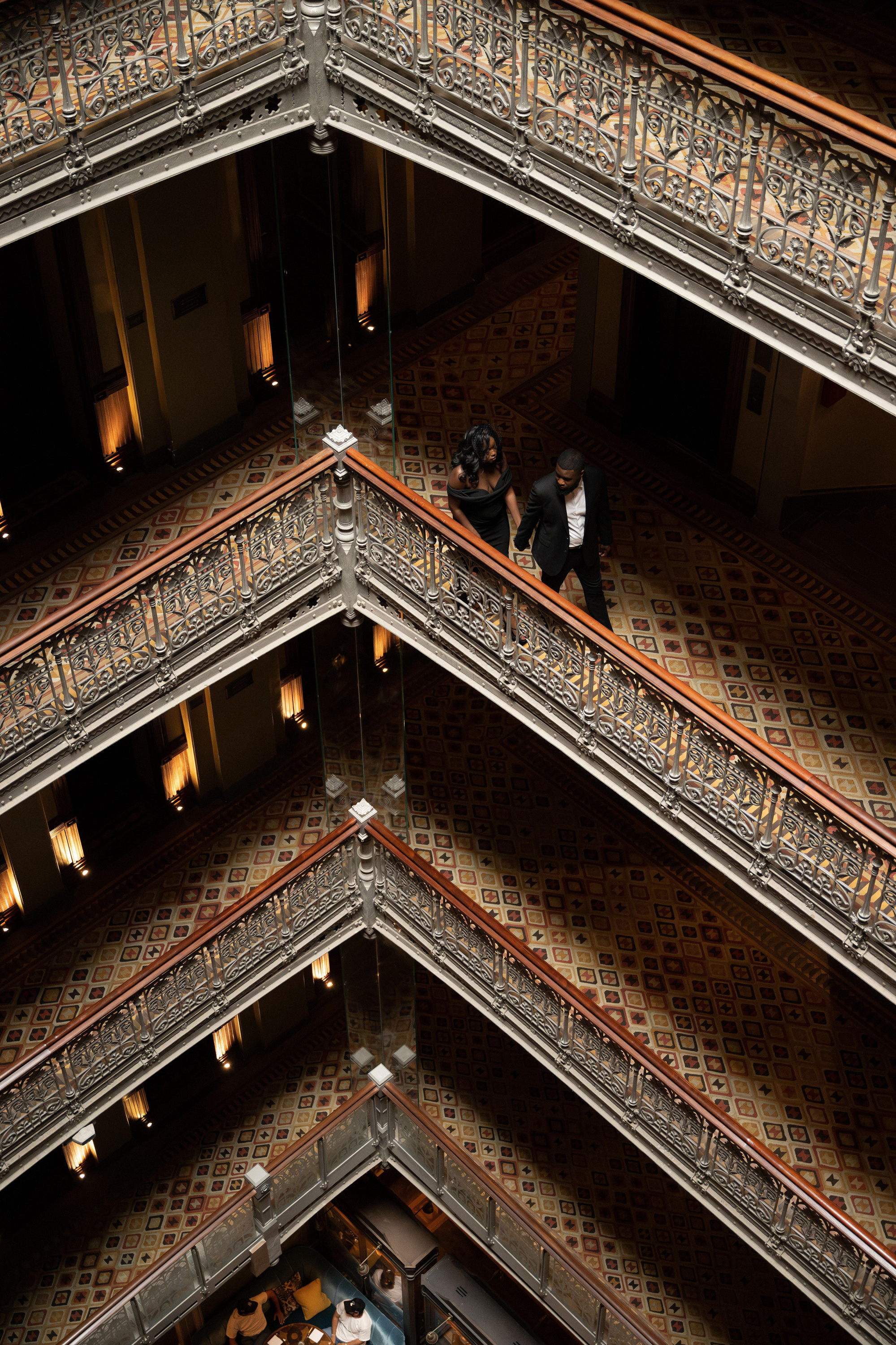 a couple of people walking down a staircase