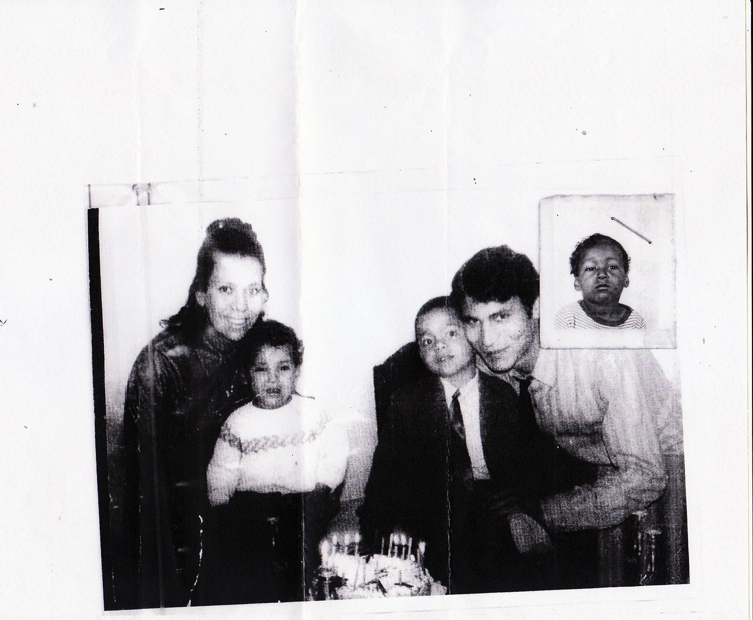Old damaged family photograph before professional restoration – faded, scratched, printed on plain paper