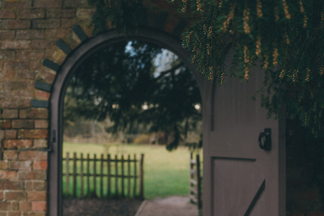 Stone archway entrance at Baddesley Clinton National Trust property, beautiful historic location for outdoor photography in Warwickshire