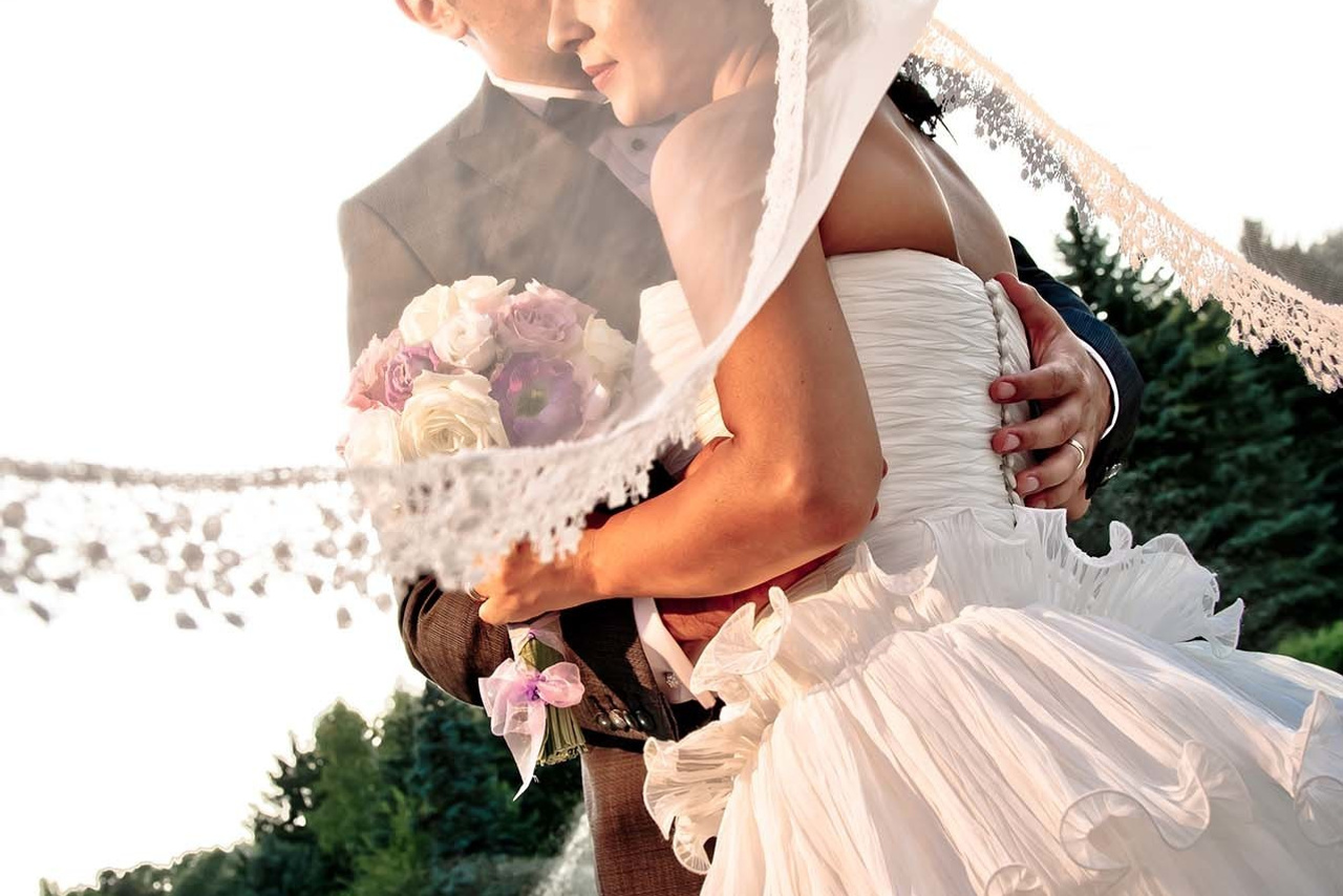 Wedding photography session Snagov Palace Bucharest Romania. Wedding photographer Nikon D850 Groom kissing the Bride veil flows