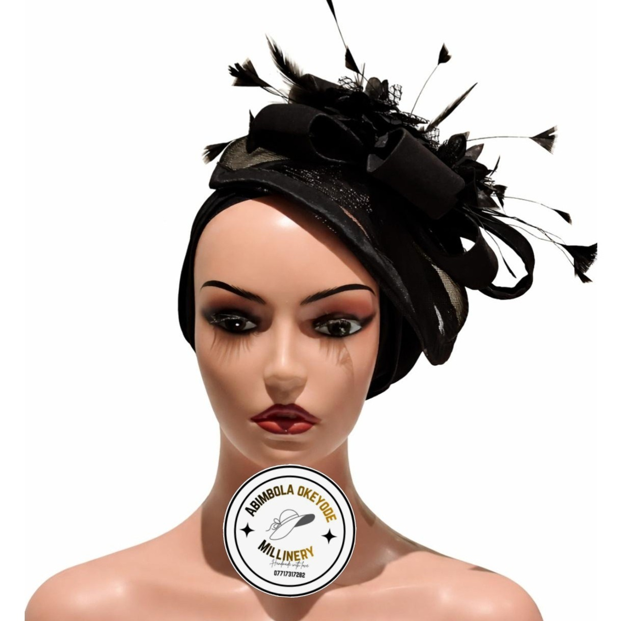 A&nbsp;pleated turban cap with an&nbsp;attached fascinator.