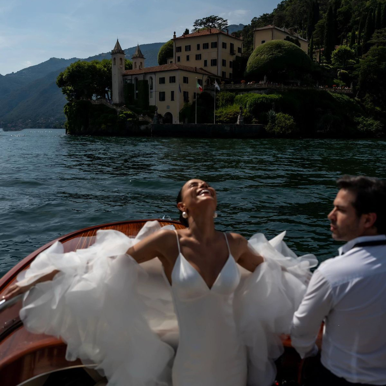 Bride and groom on a luxury boat during a Lake Como destination wedding editorial