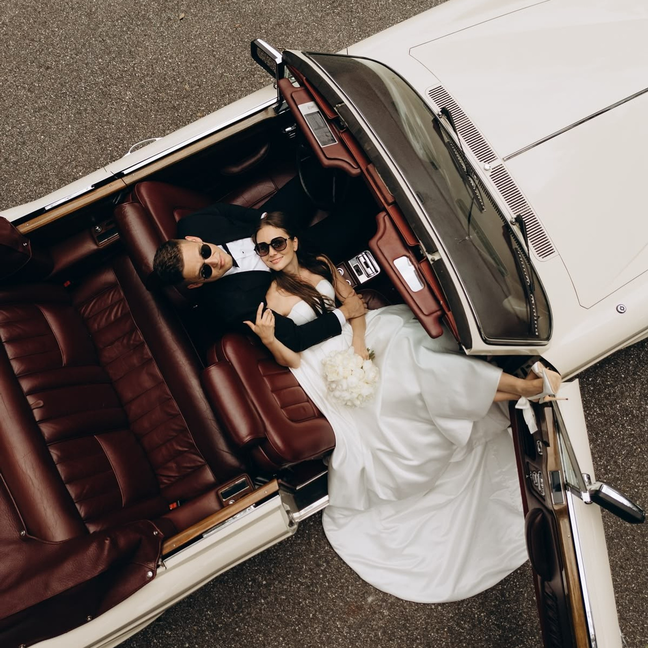 Bride and groom on a luxury retro car wedding editorial