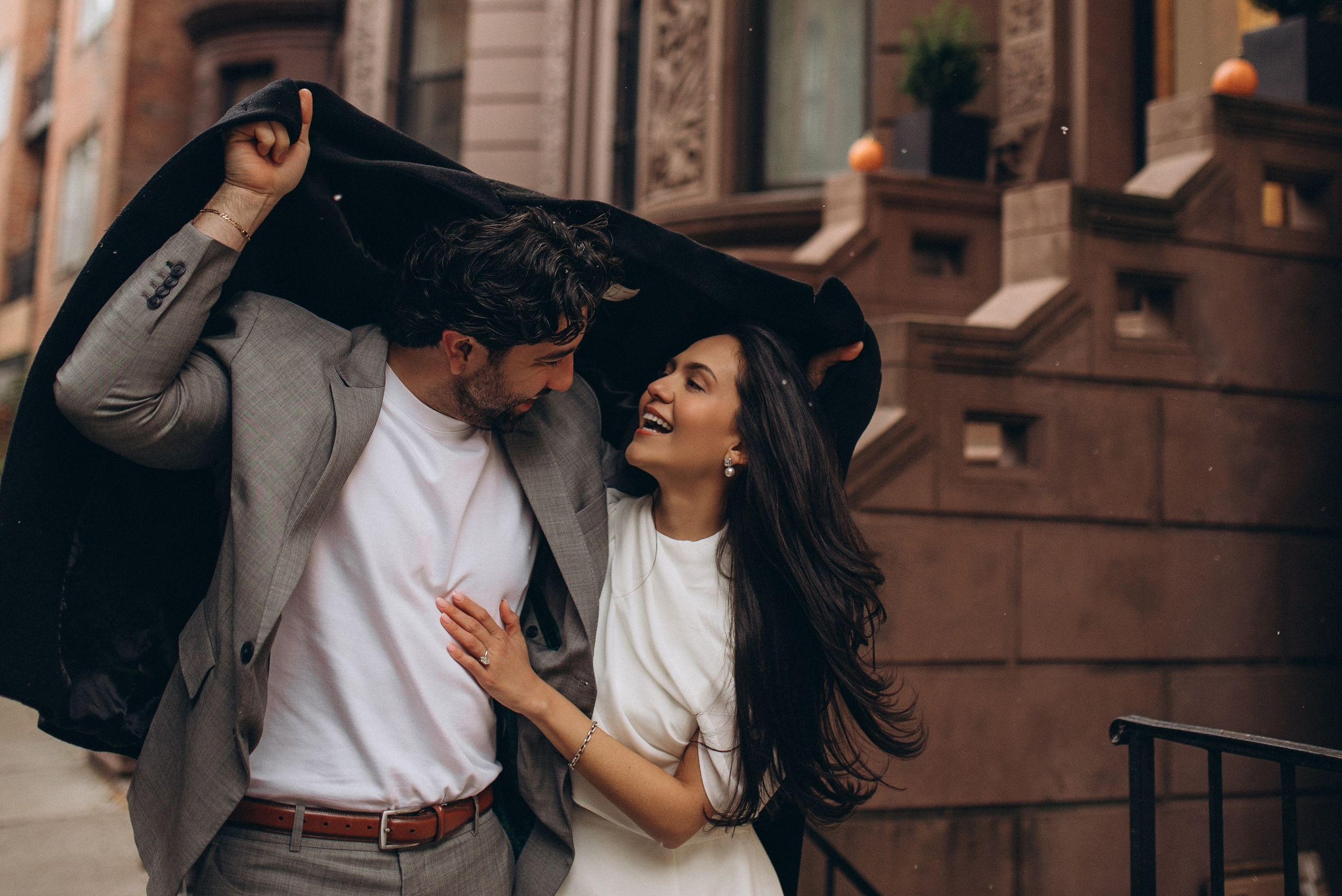 Couple kissing in Manhattan across a New York City street with a yellow taxi in the background — lifestyle engagement photo with cinematic vibe