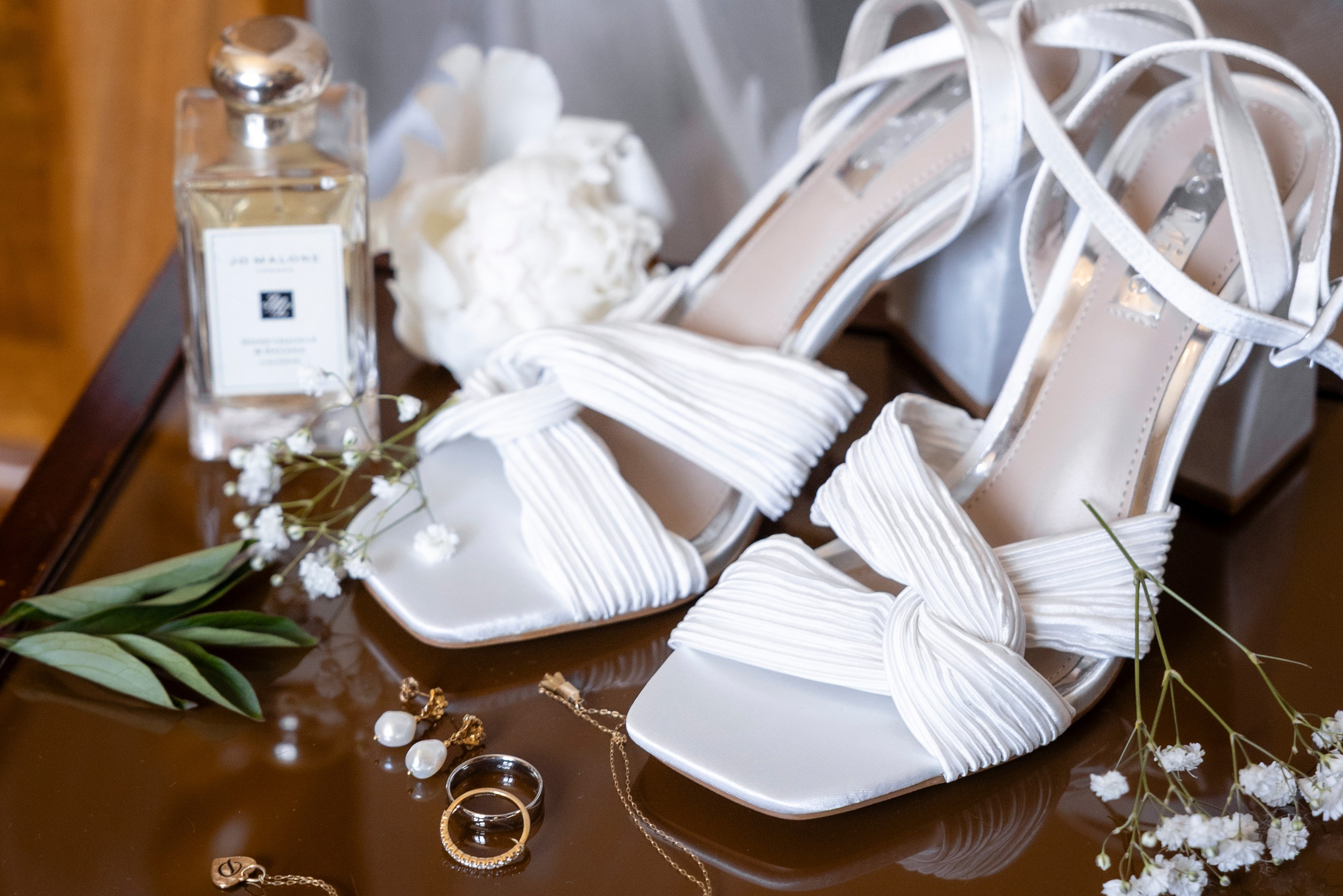Wedding shoes and bridal details during preparations in a French château room
