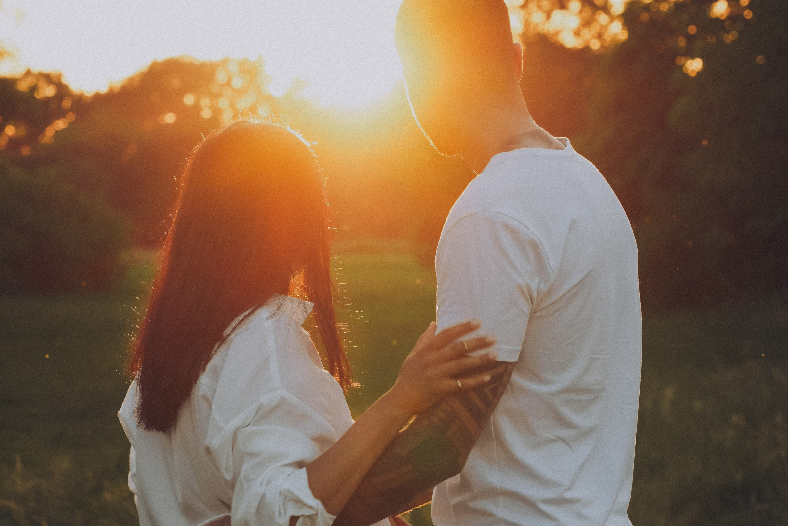 Pregnant couple embracing outdoors, natural light maternity shoot Solihull