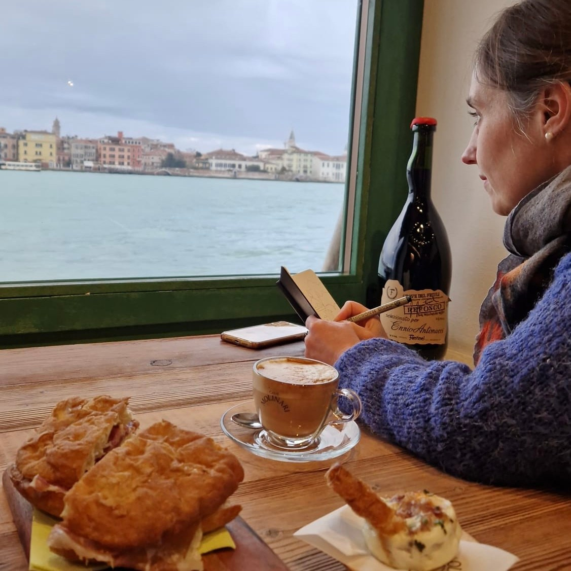 Artist sketching live at a café table in Venice, during a private art experience with a local artist