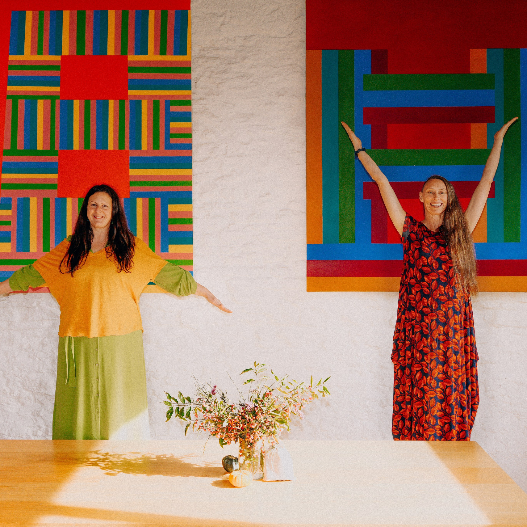 Brand storytelling photography of two women in a creative, colourful interior setting
