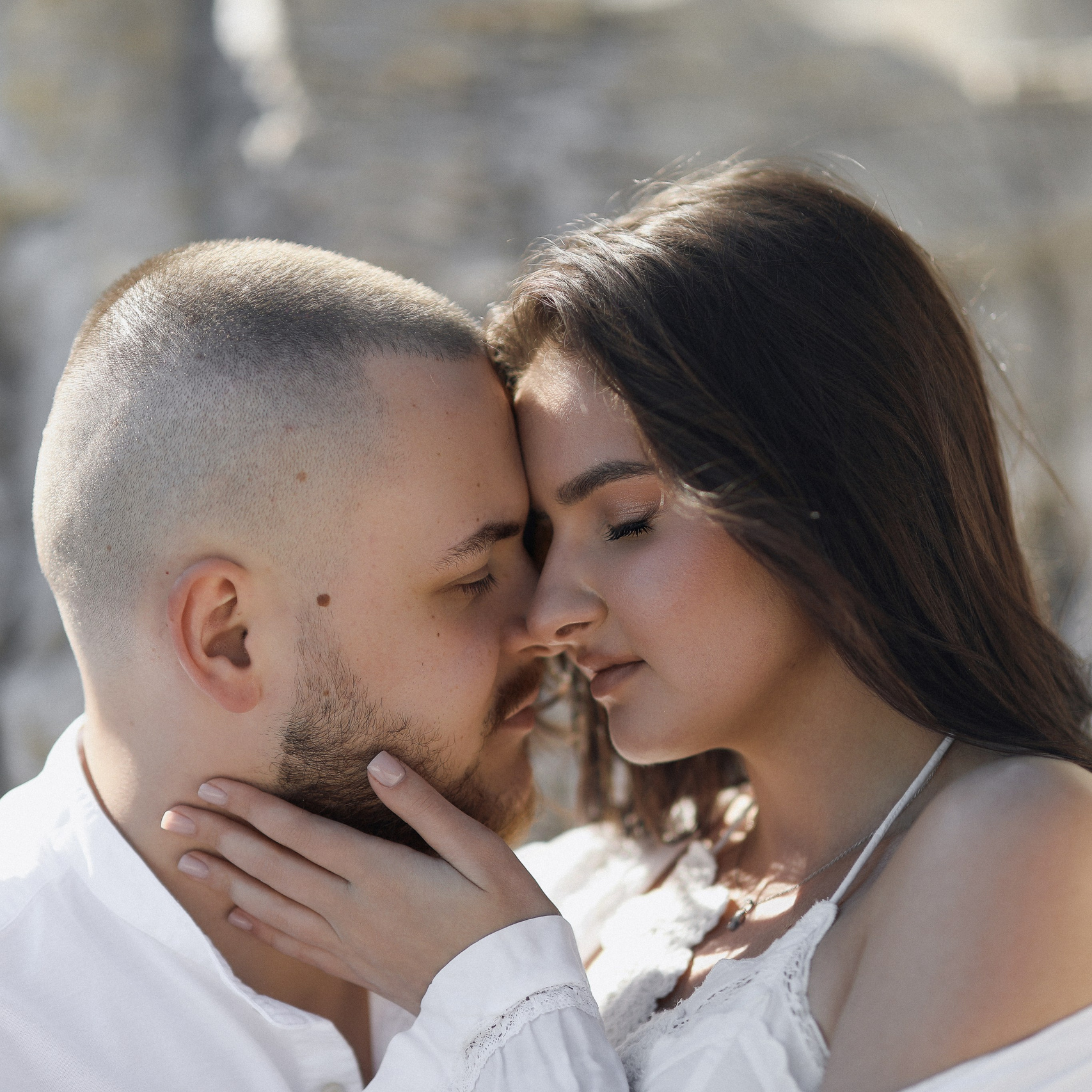 Bride standing by the sea in Croatia during a wedding photoshoot at sunset