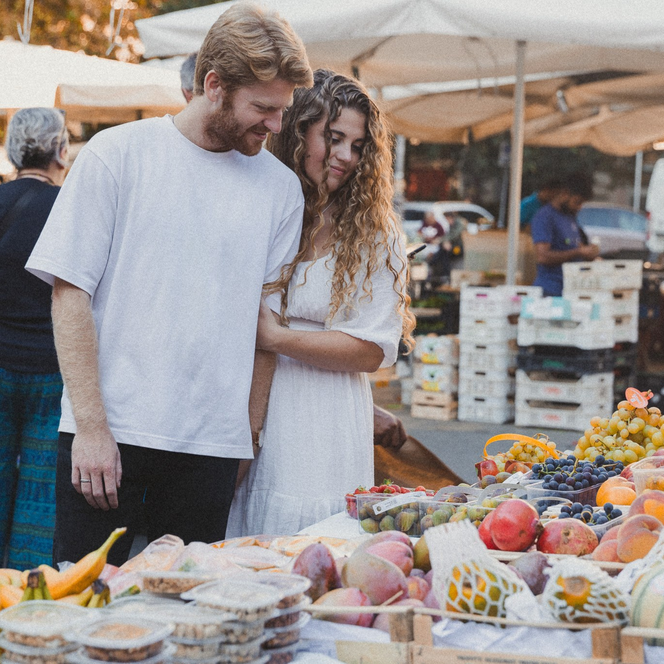 Couple embracing on a cobblestone street in Trastevere, Rome.