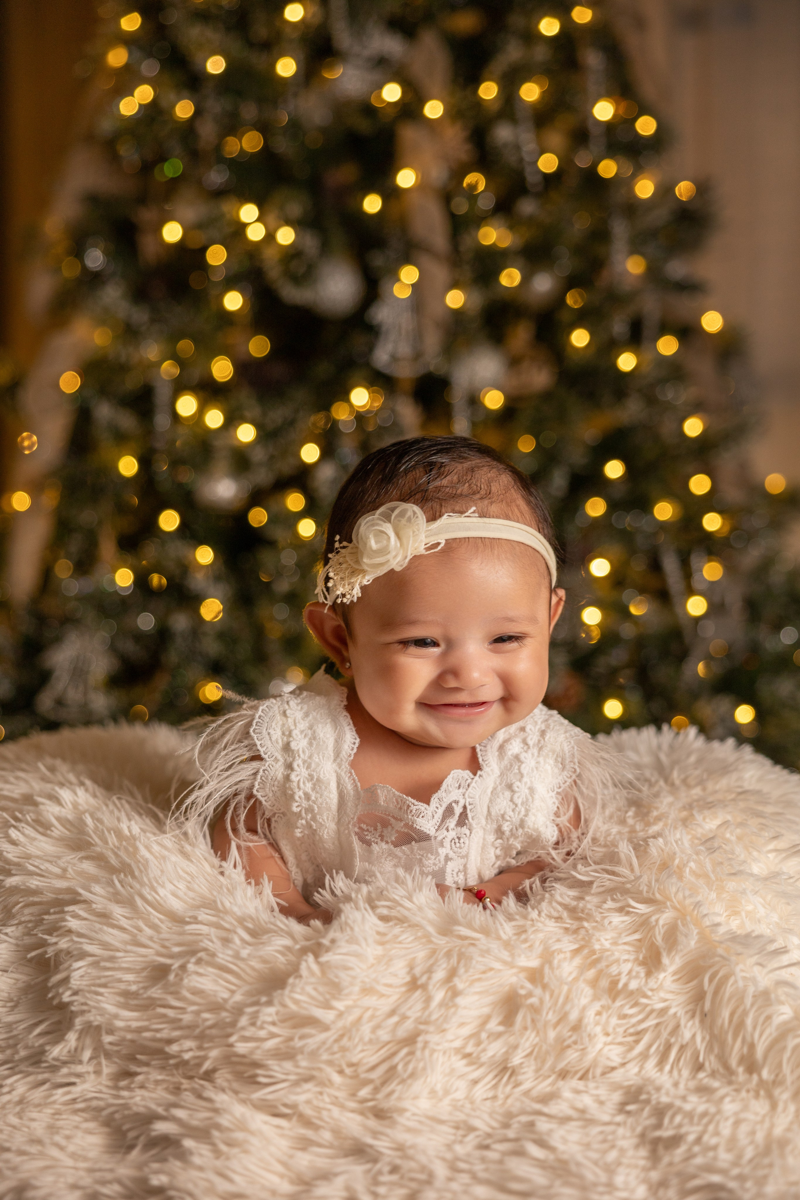 Christmas baby photo under the Christmas tree and lights