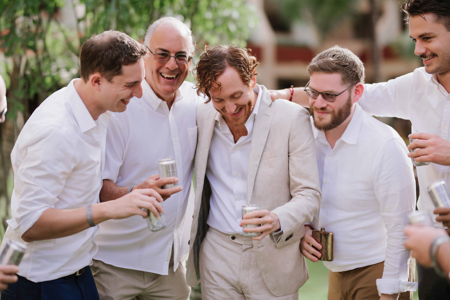 Friends of the groom and the groom pose for a photographer. 