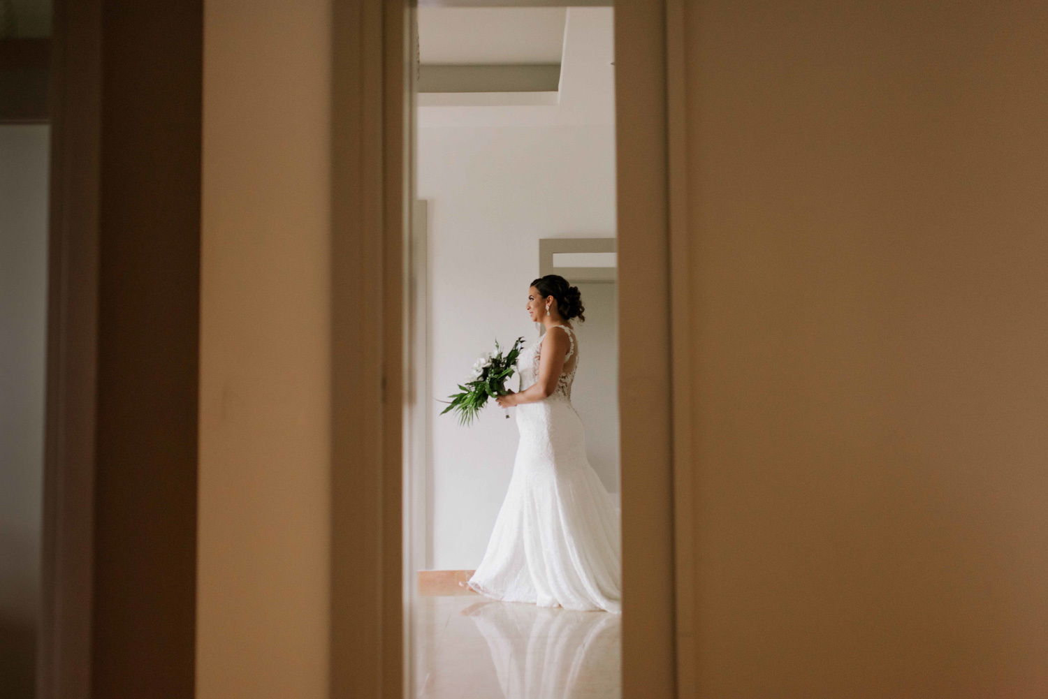 A bride with a wedding bouquet posing for a photo.