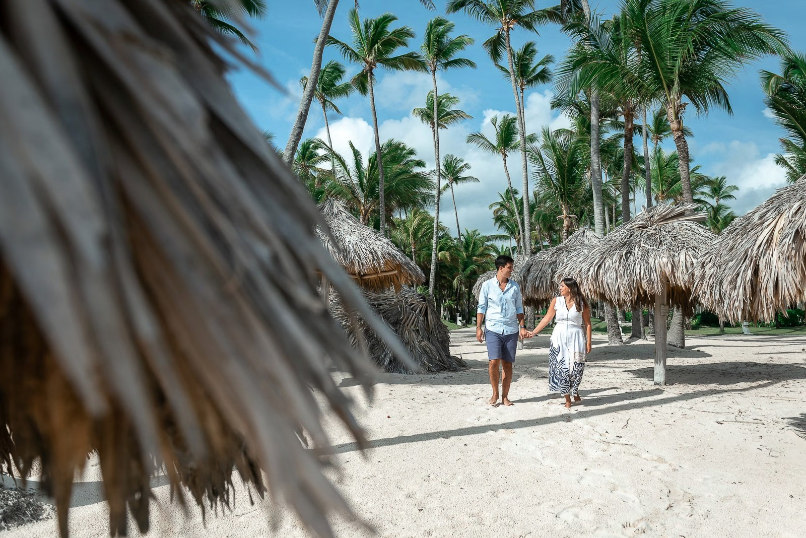 Couples photoshoot under palm trees on Bavaro Beach in the Dominican Republic