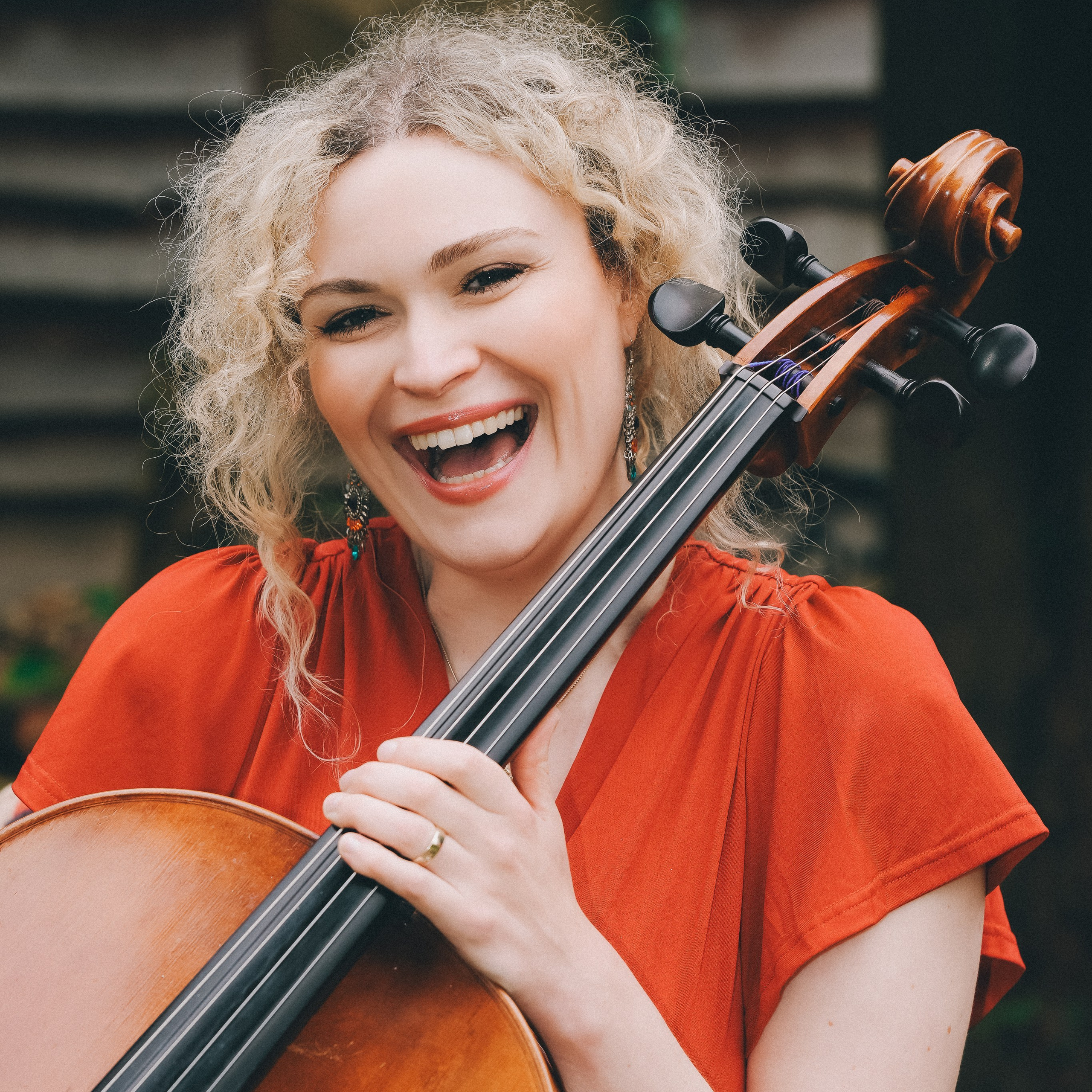 Natural brand portrait of a musician playing the cello in an outdoor setting