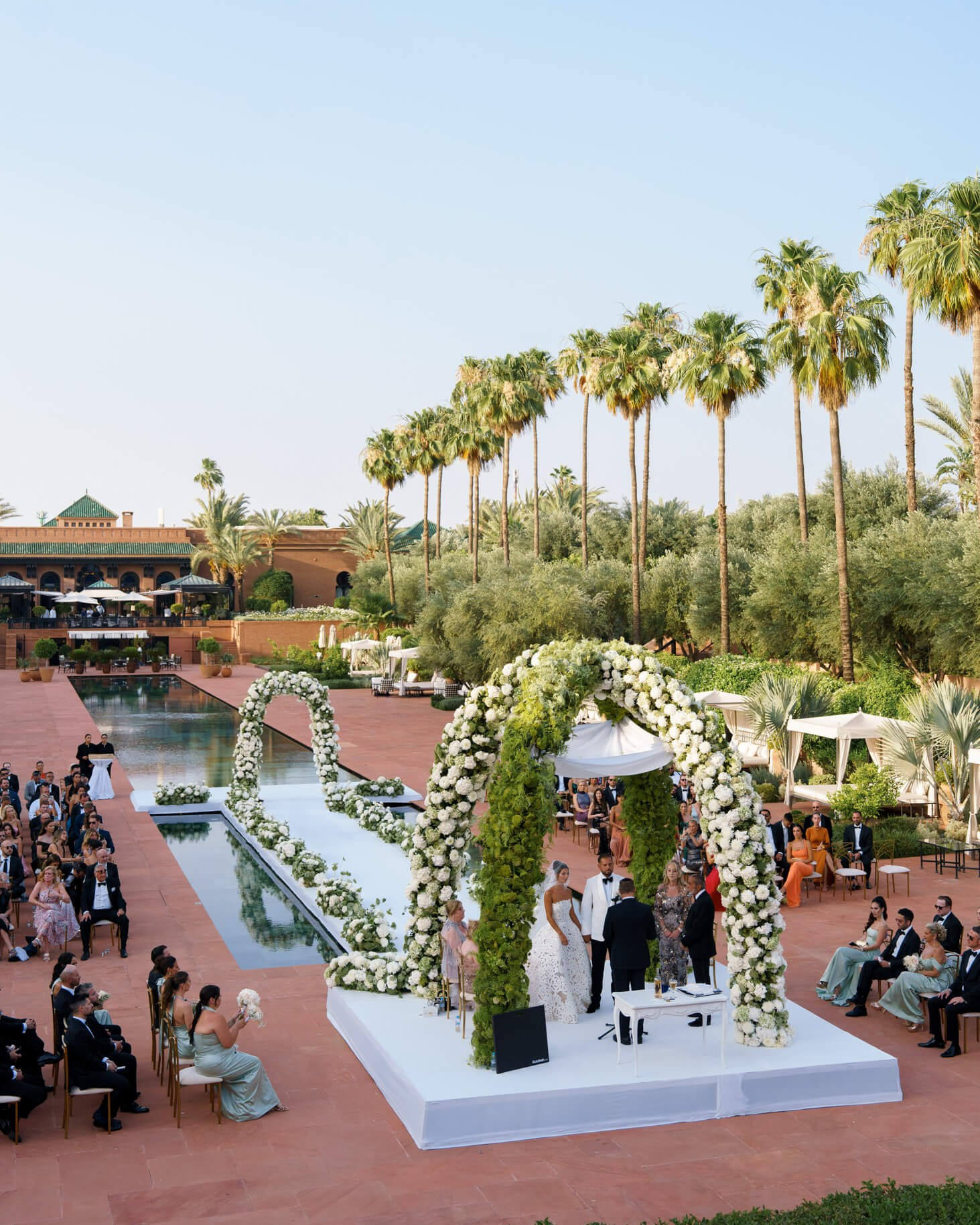 Luxury outdoor wedding ceremony setup at a palm garden venue in Marrakech, Morocco