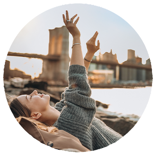Lifestyle portrait in Brooklyn Bridge Park, moody tones, authentic expression