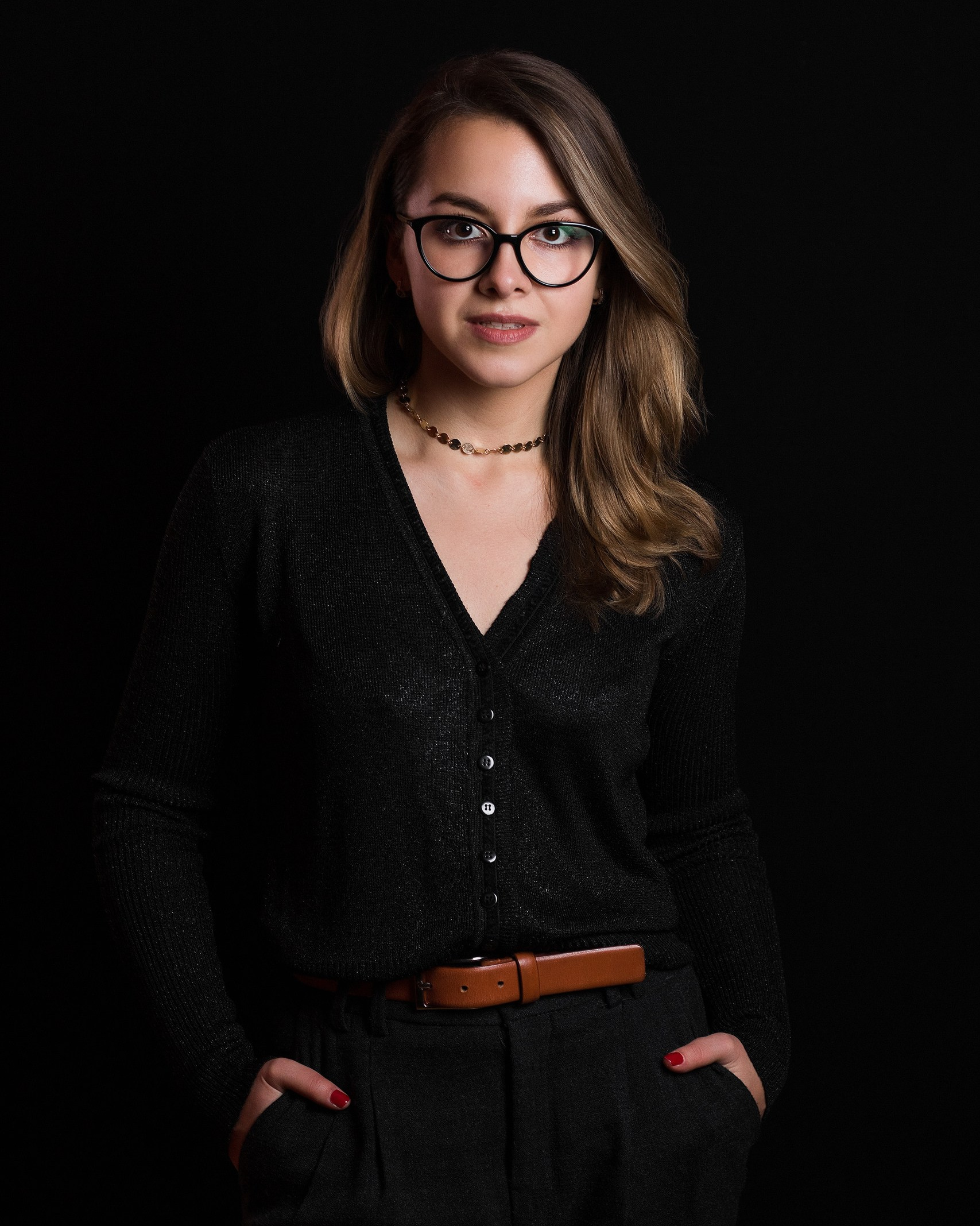 Professional business headshot woman in black cardigan dark background studio Edmonton