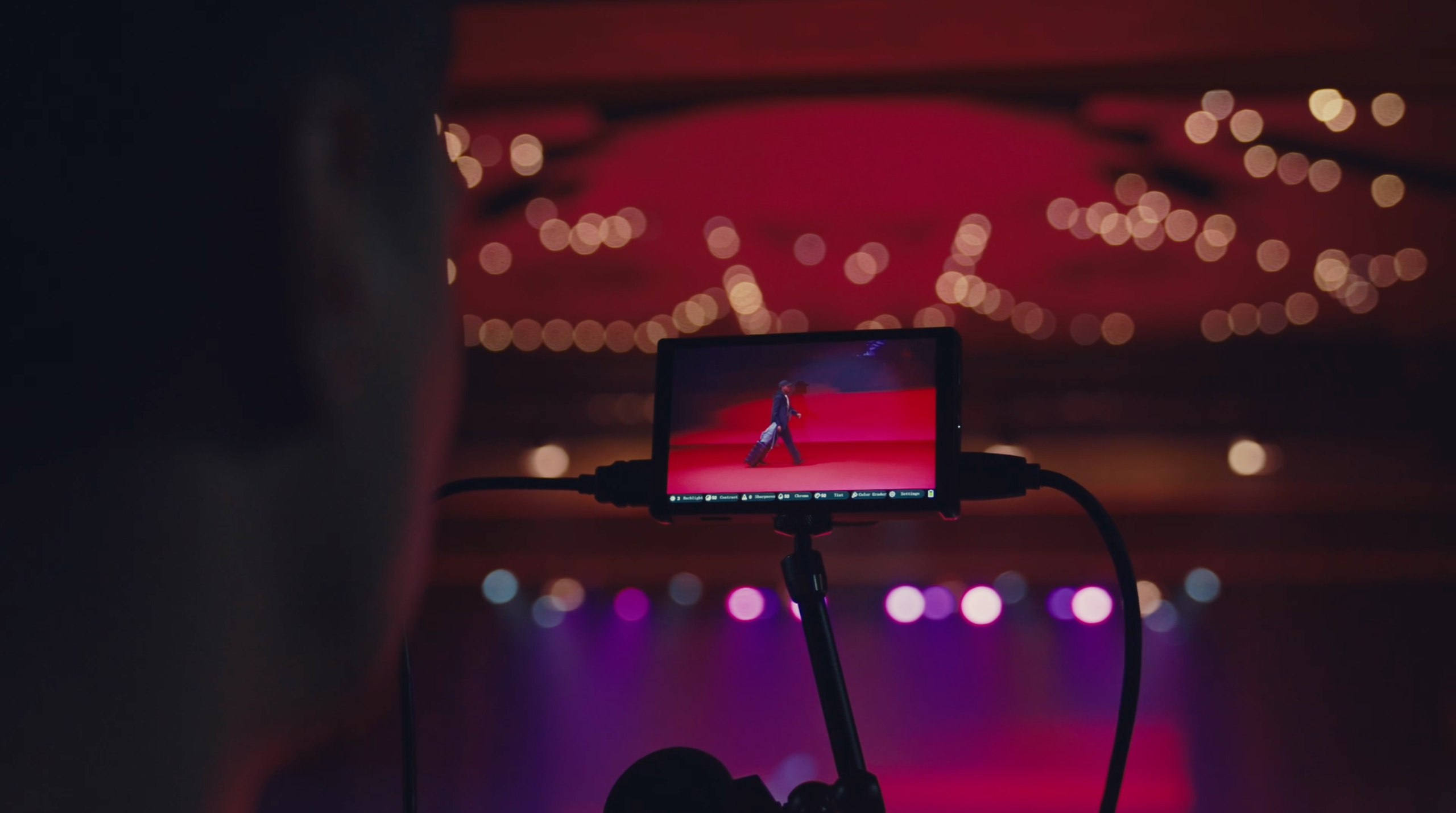 Production camera monitor framing a corporate event stage before a live broadcast in the UAE