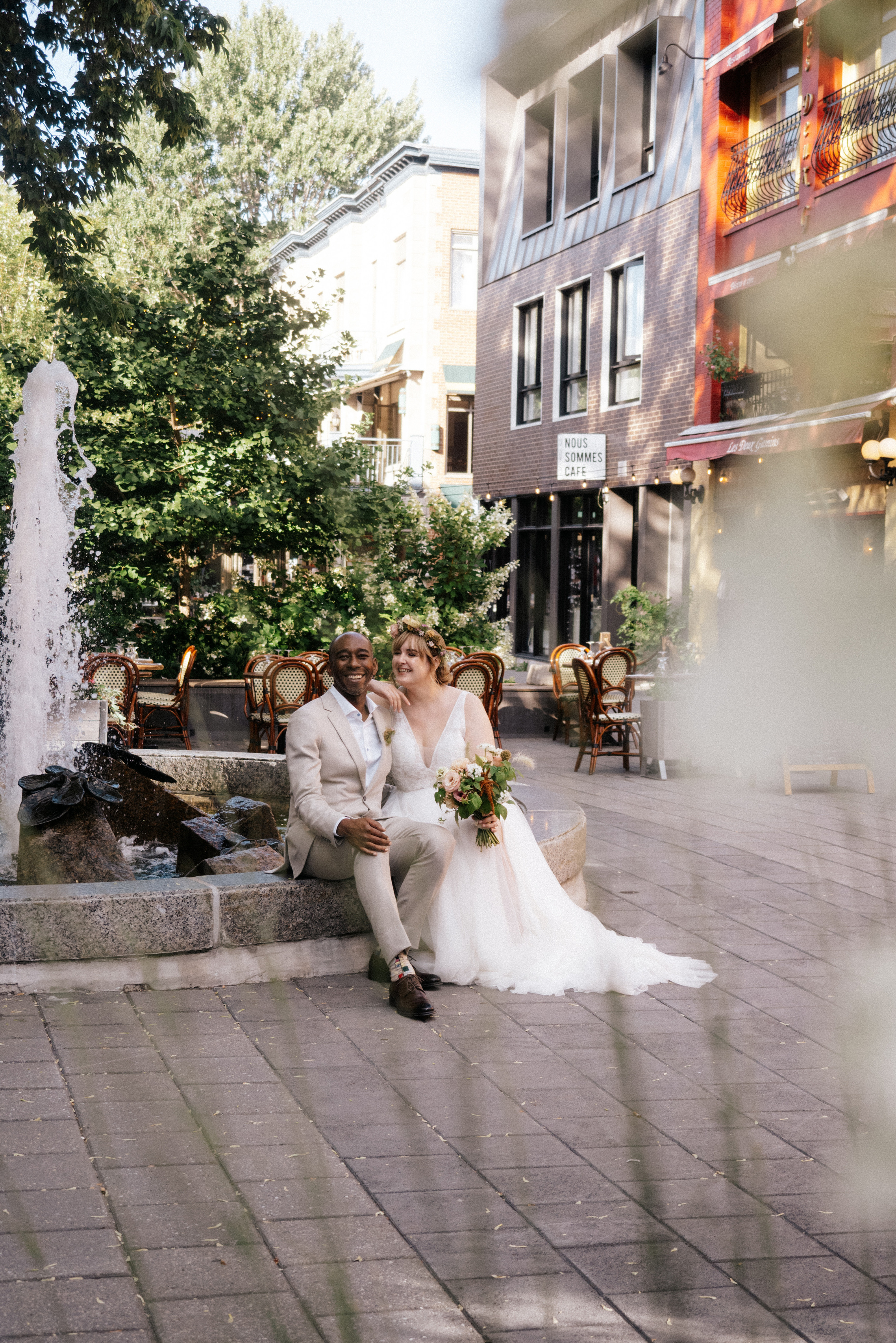 Couple getting married sitting on fountain in Montreal, Canada. 