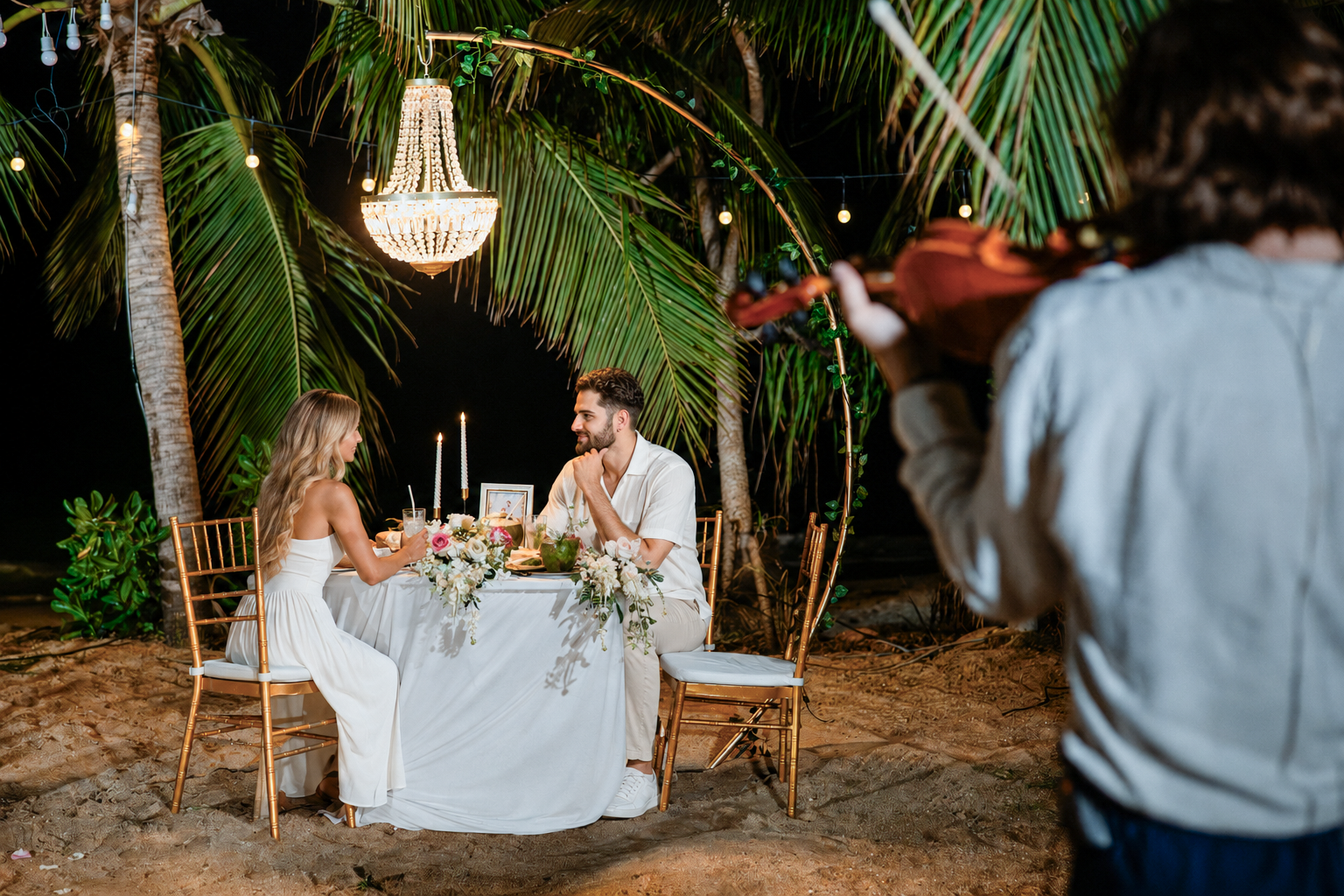 Romantic beach proposal setup in Koh Samui, Thailand with candles, flowers and ocean sunset view.