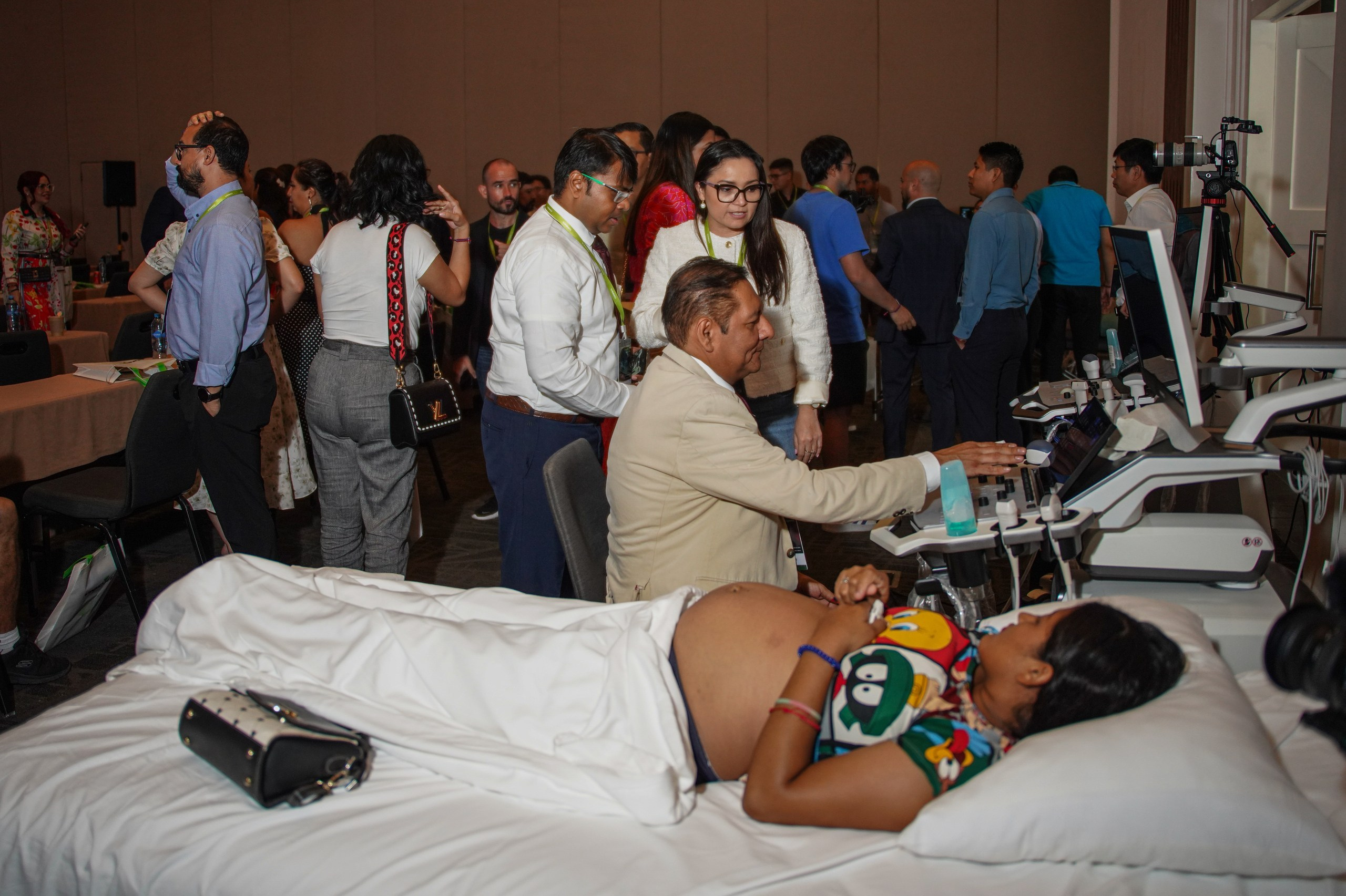 Medical expert demonstrating new diagnostic equipment to event attendees.