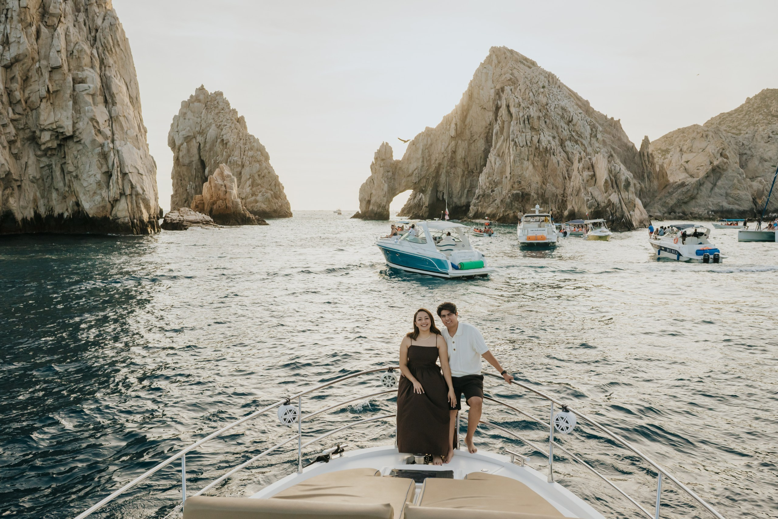 Newly engaged couple with El Arco de Cabo San Lucas